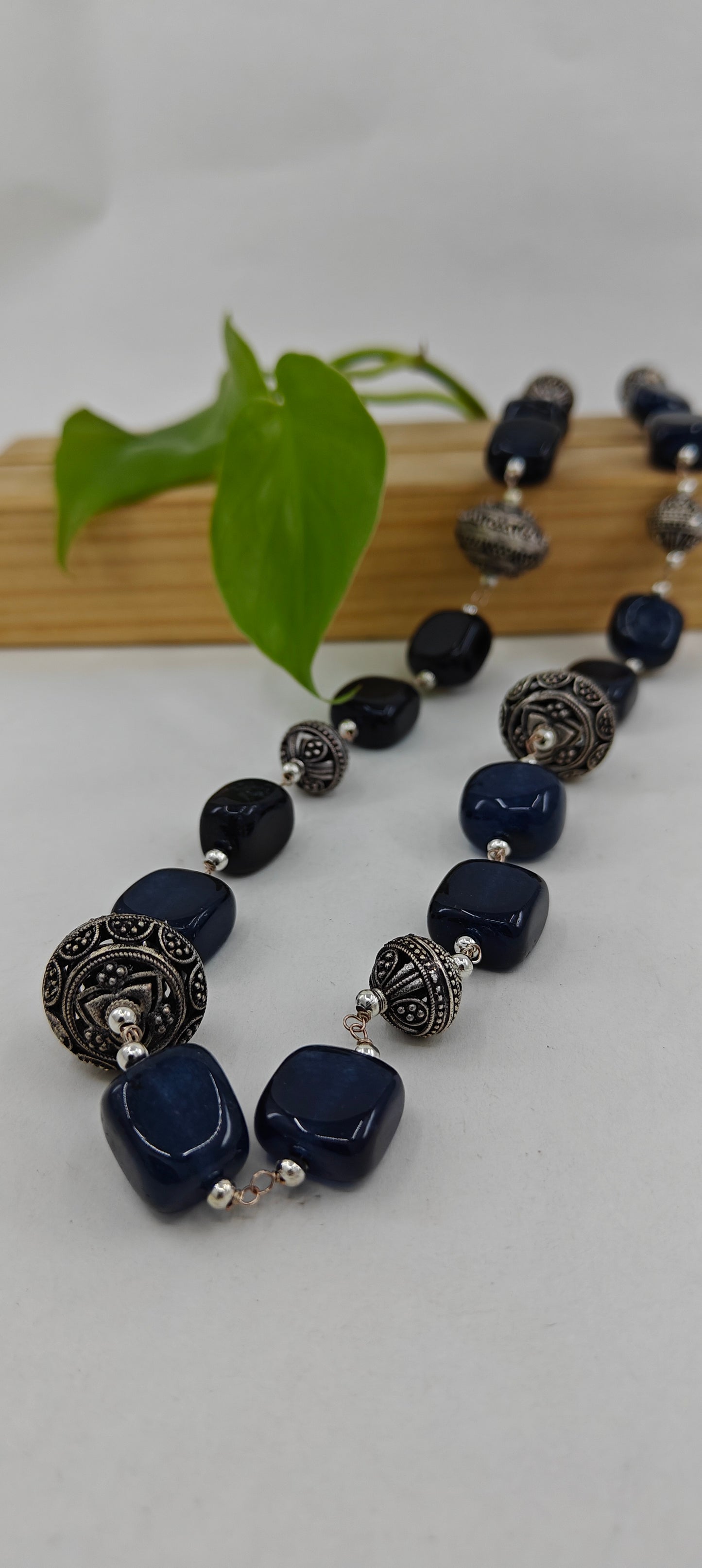 Set in black stone and jali beads