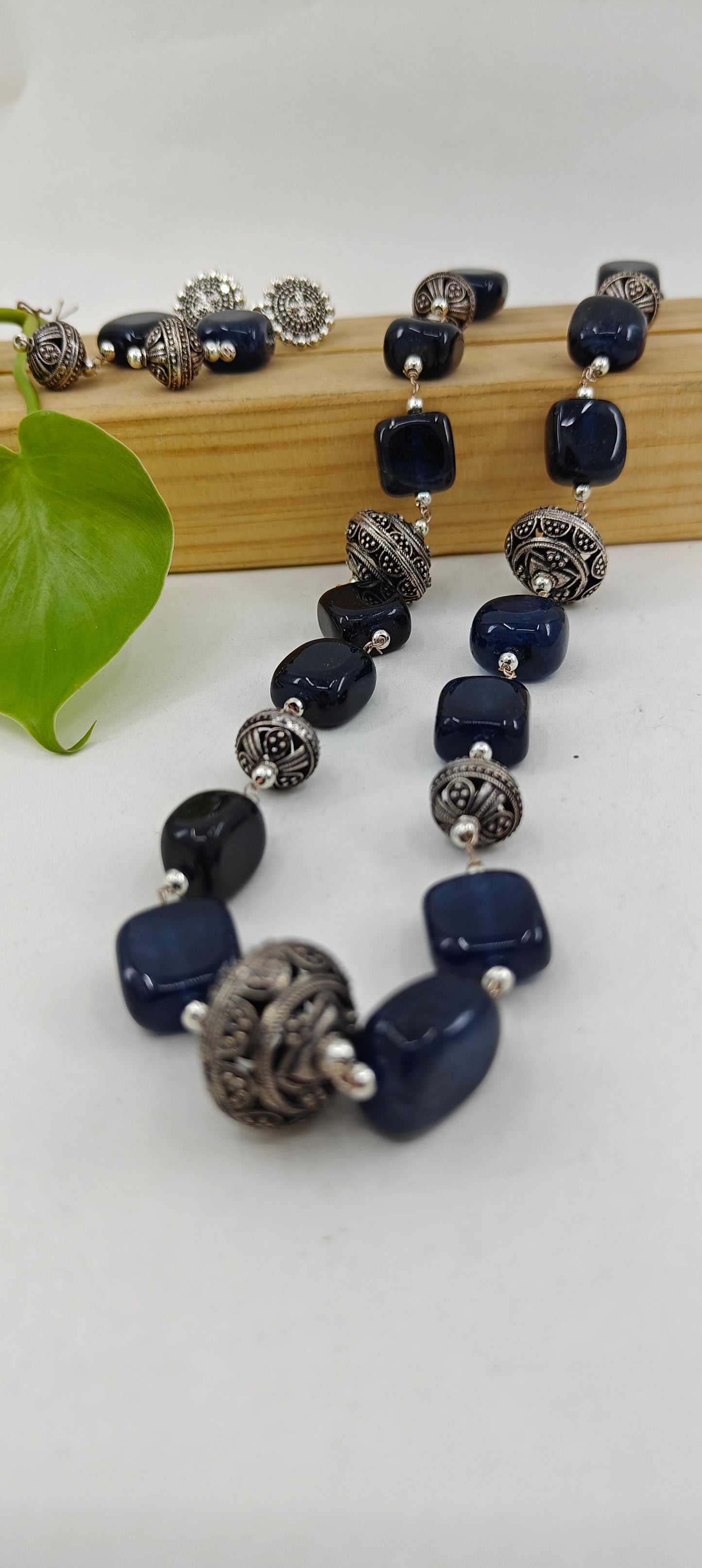 Set in black stone and jali beads