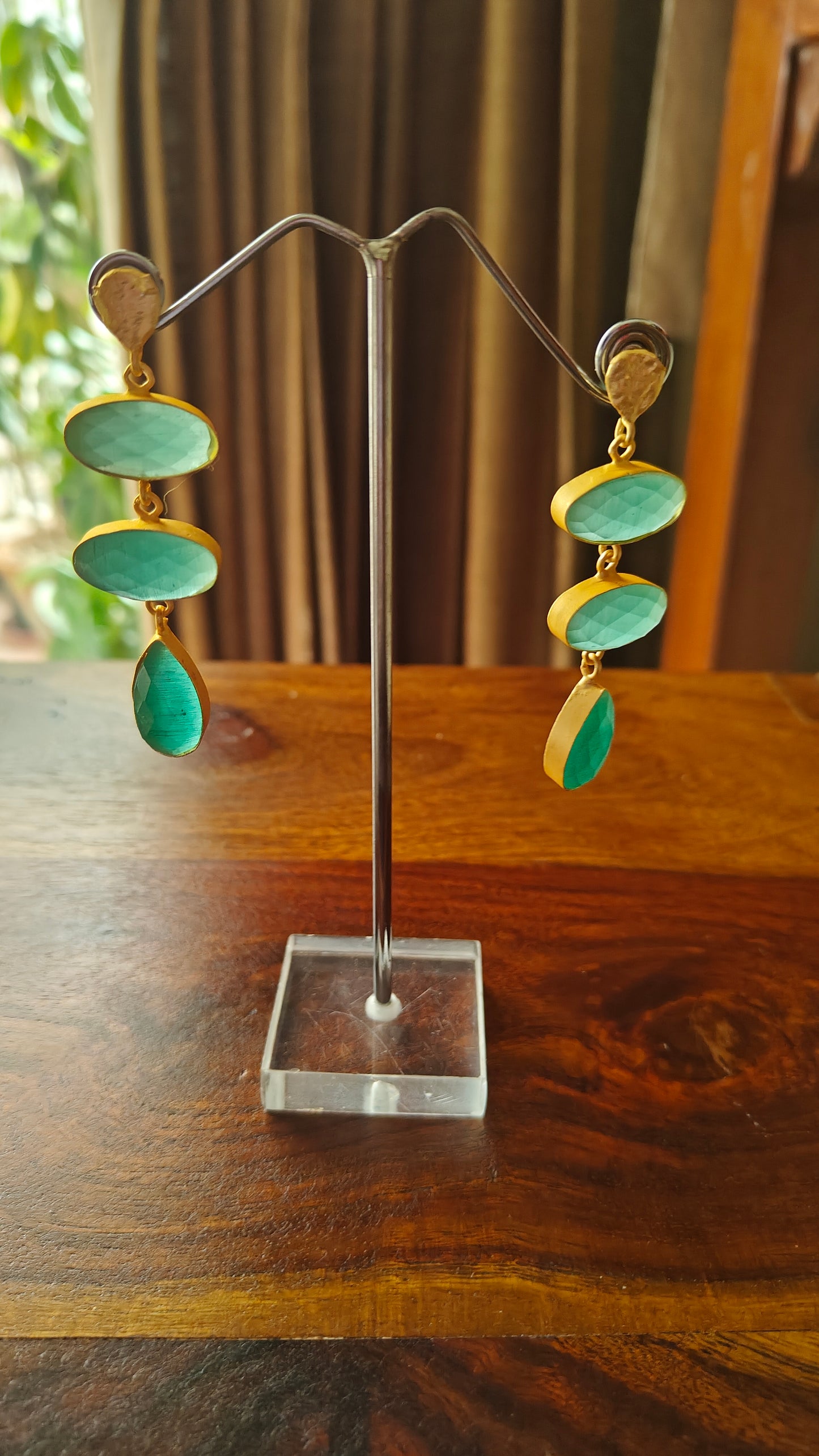 Hanging earrings in a golden frame with stones.