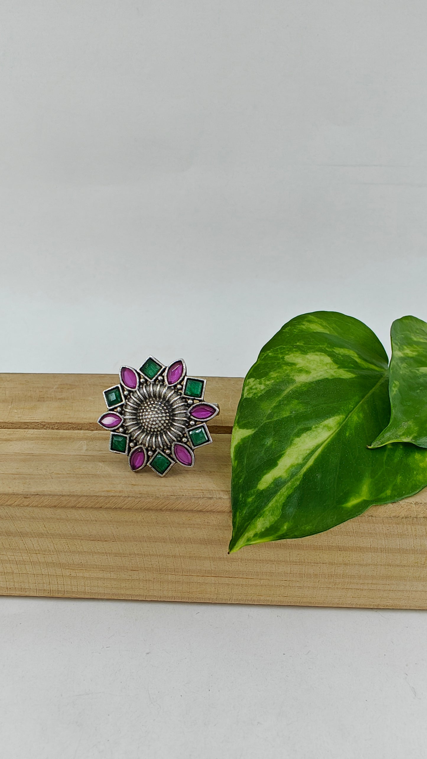 Silver flower motif ring with stones