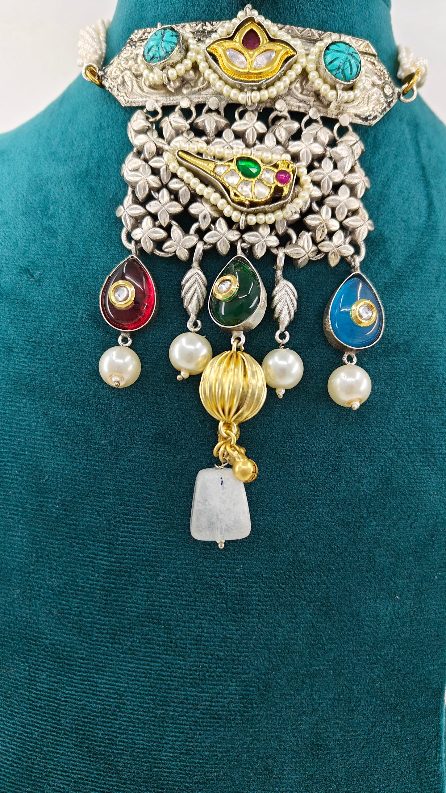 Necklace in dual tone with pendant with chattai work, pearched peacock with pearls,kundan and big stone hangings on poth pearls strings