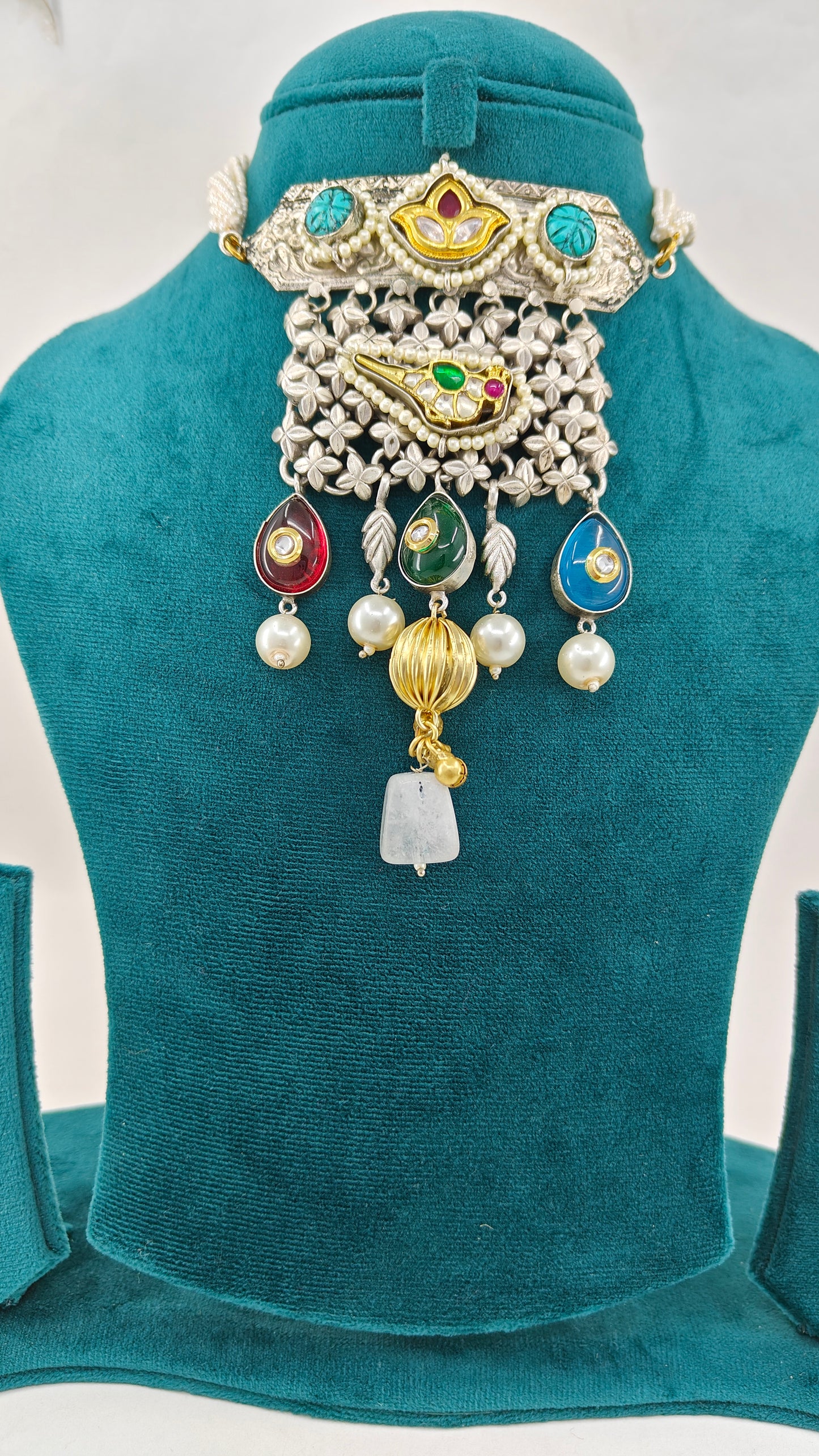 Necklace in dual tone with pendant with chattai work, pearched peacock with pearls,kundan and big stone hangings on poth pearls strings