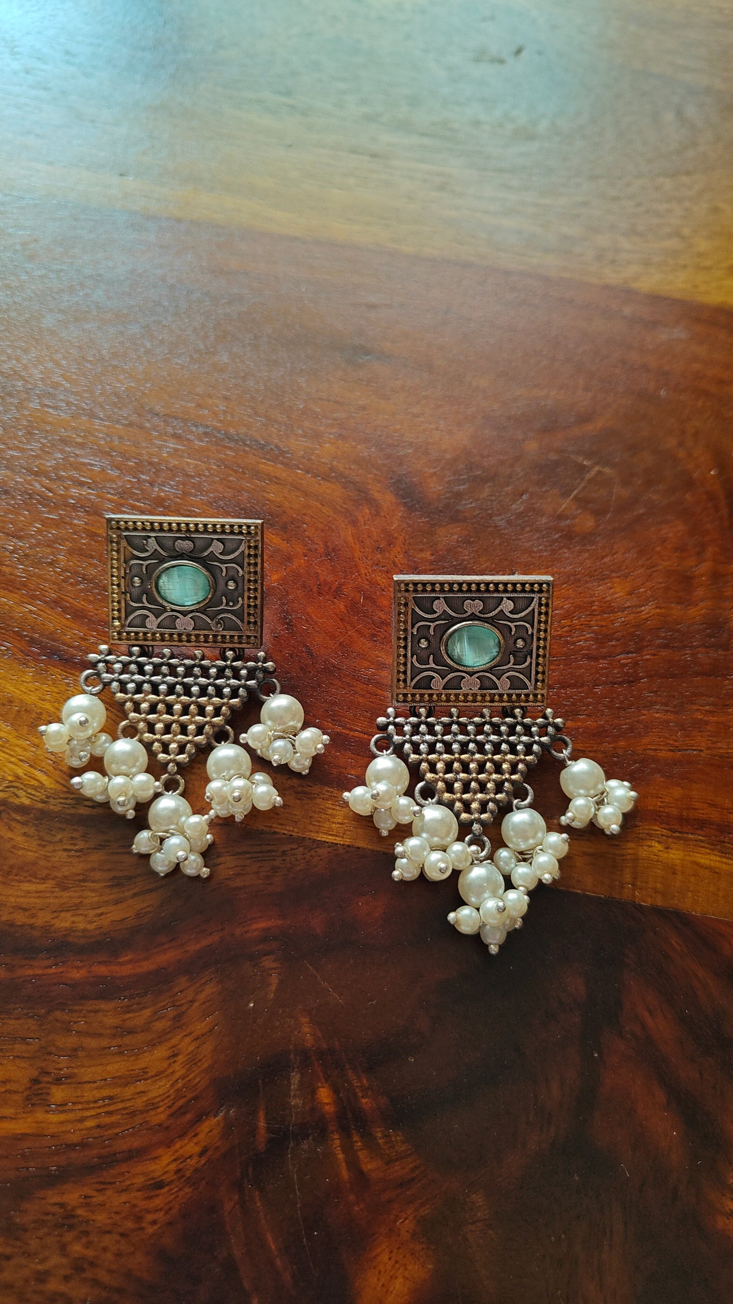 Earrings in dual tone with triangular hangings with pearls