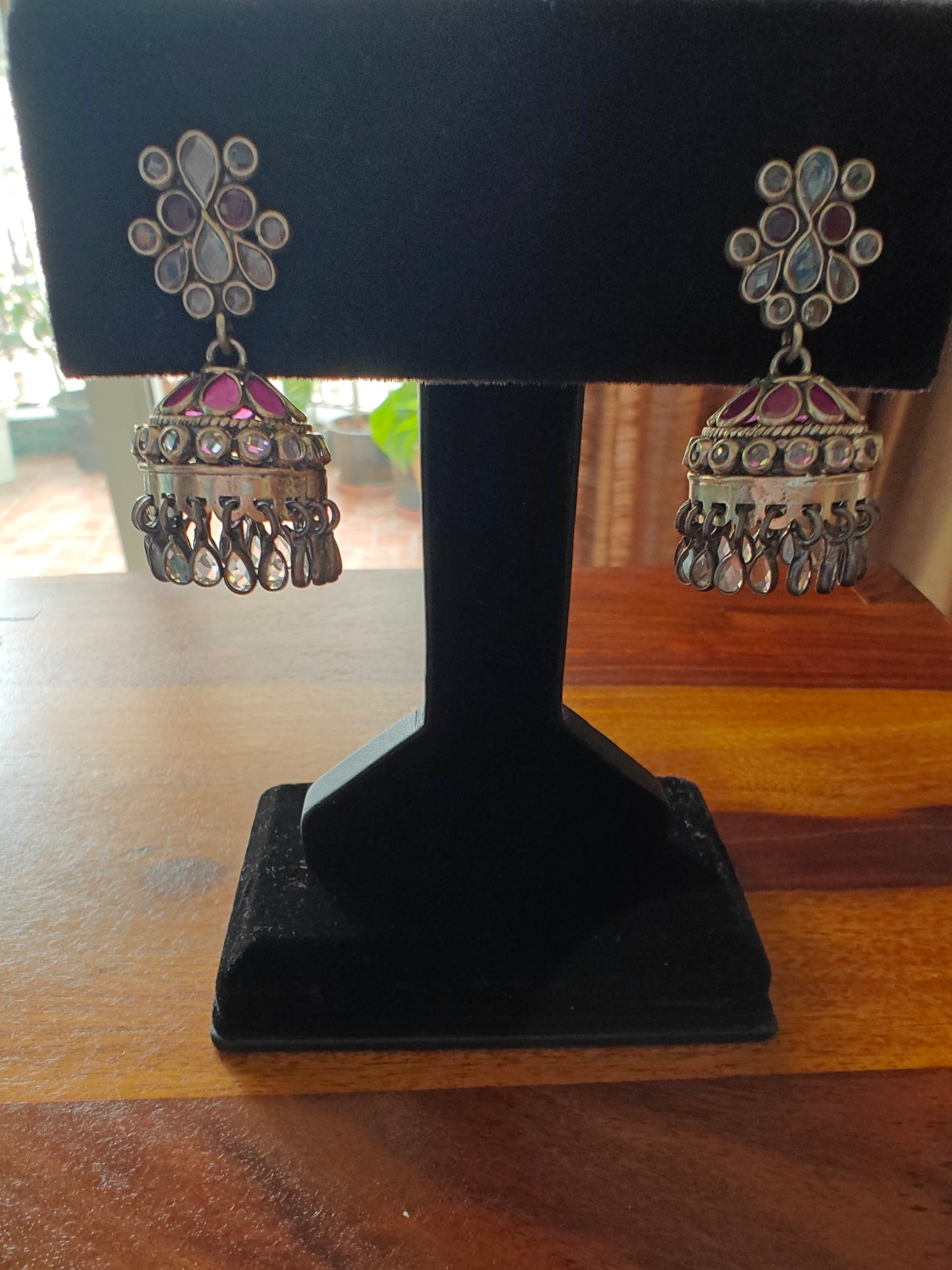 Deepti silver jhumkis with ruby pink and transparent stone