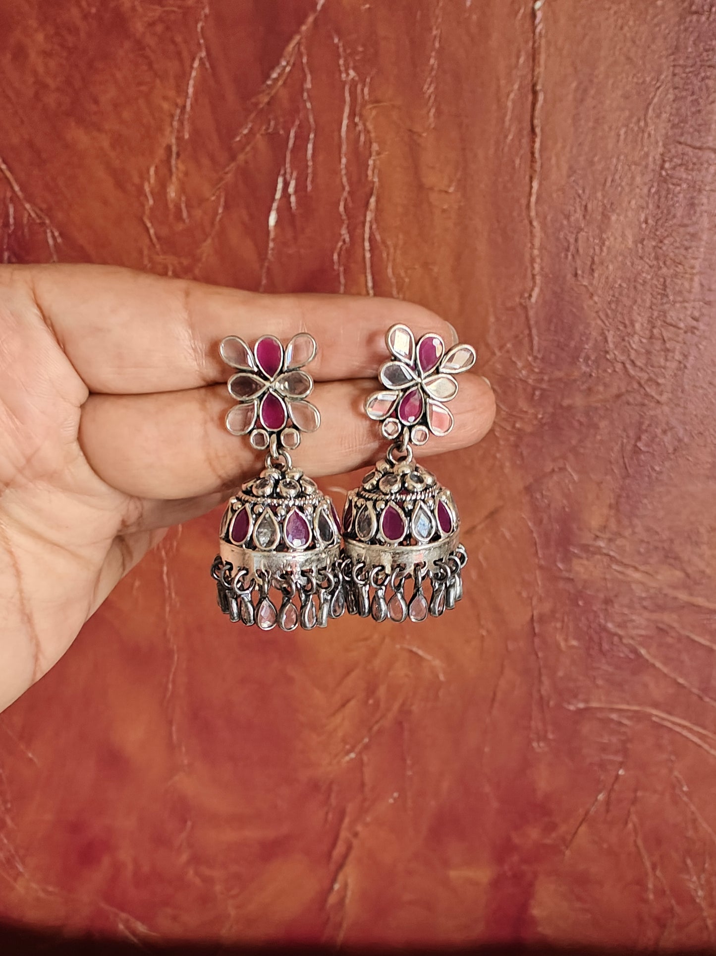 Deepti silver jhumkis with ruby pink and transparent stone