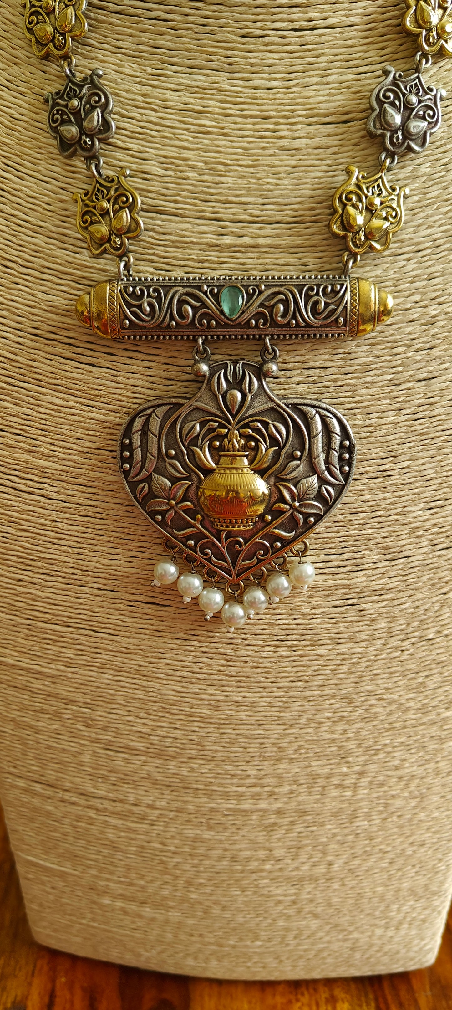 Dual tone kalash pendant on necklace with carved pieces