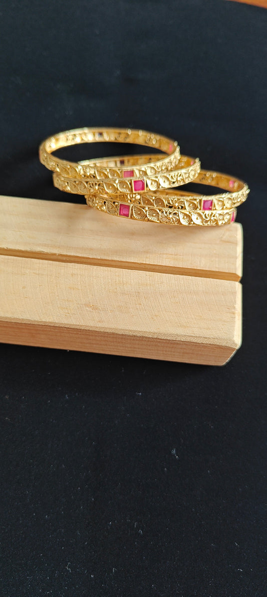 Carved bangles with ruby red stone highlights(4 pc)