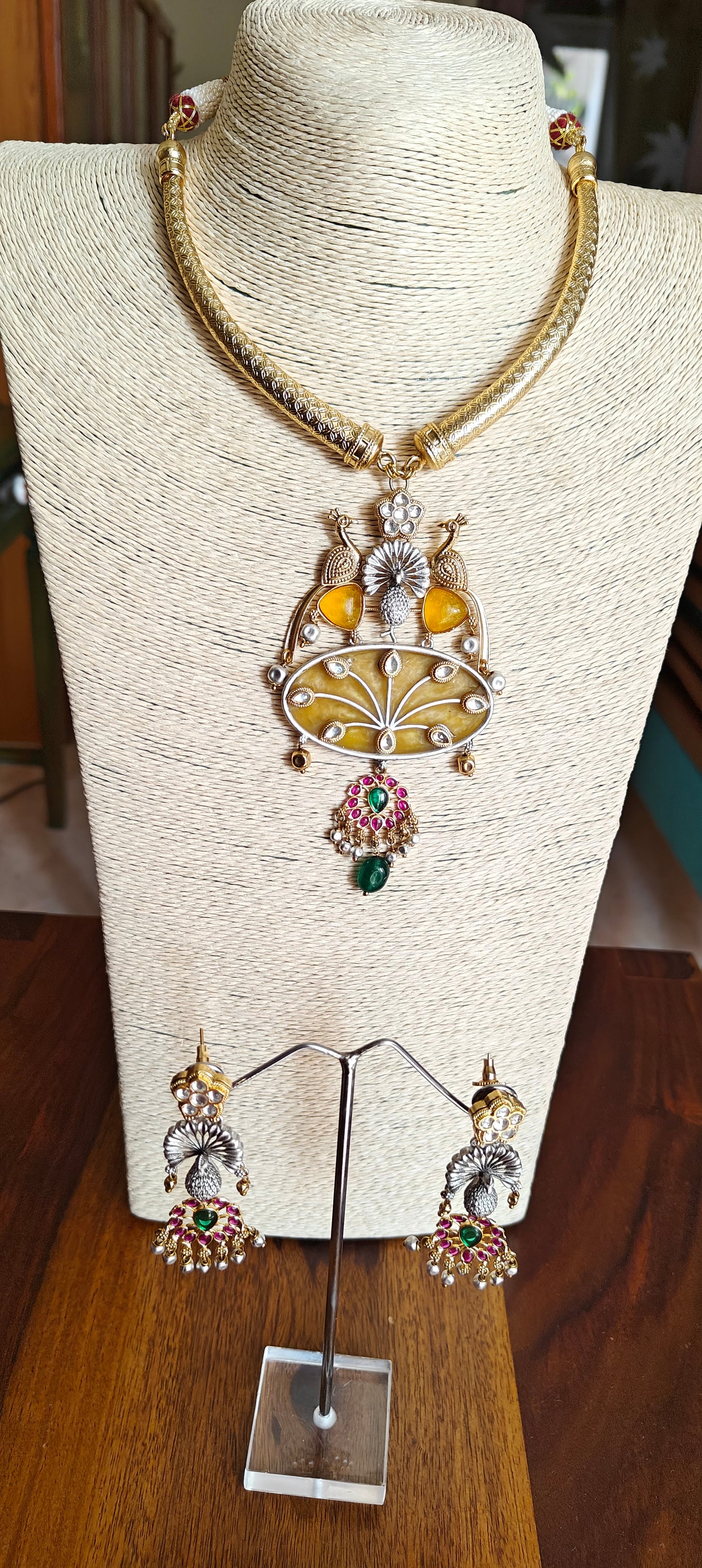 Hasli set in dual tone, pearched peacocks on stone pendant with Kundan work, matching earrings