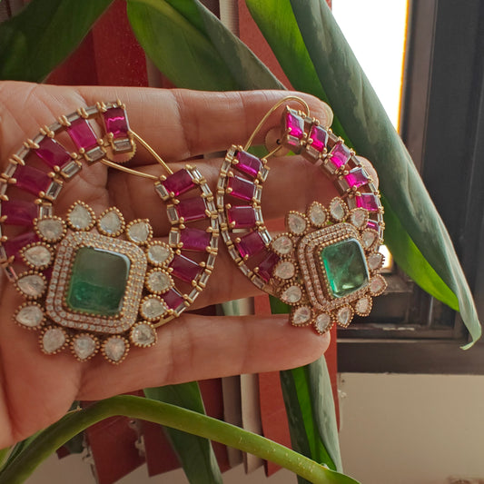 Elaborate earrings with ruby and emerald green stone