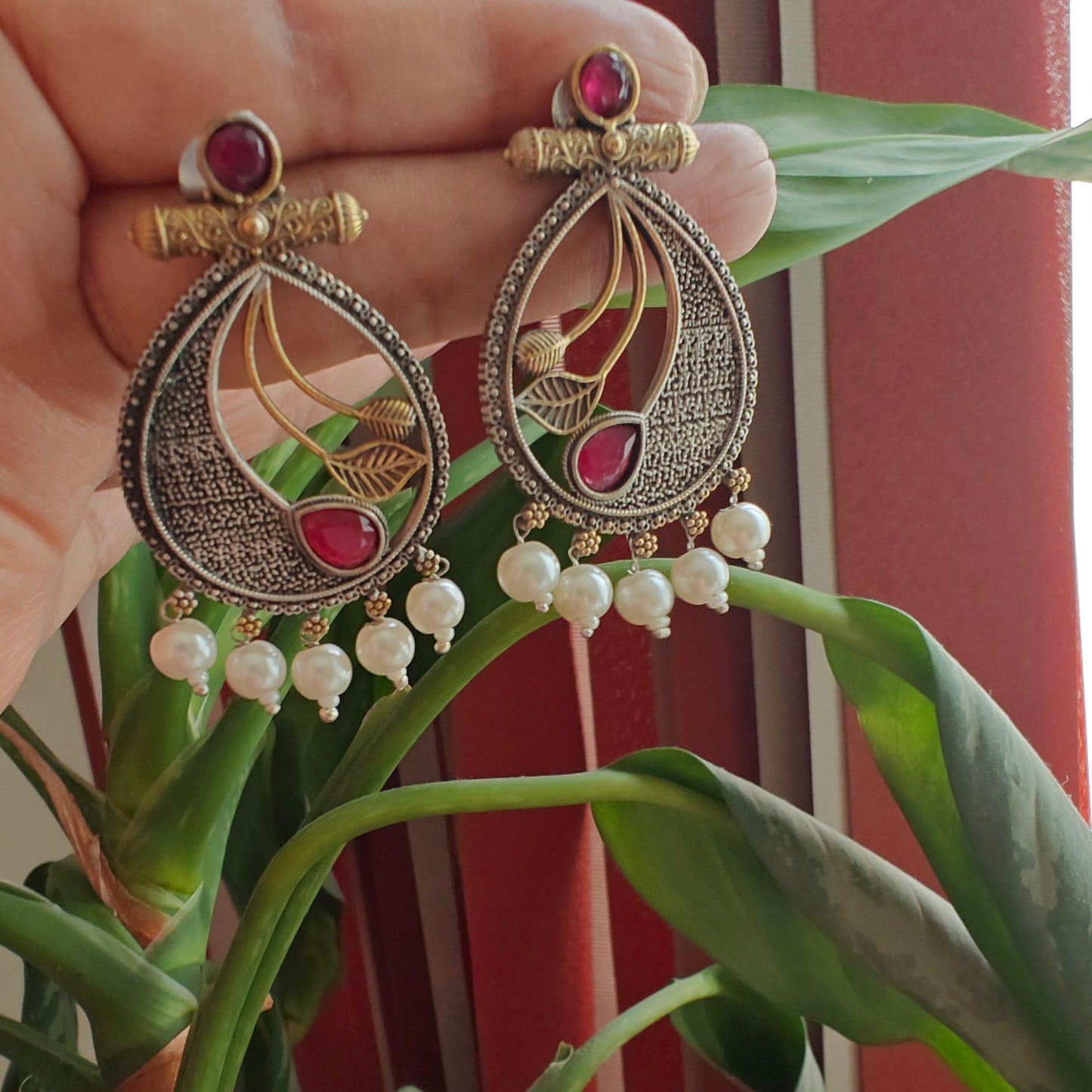 Dual tone earrings with coloured stone with petals in centre