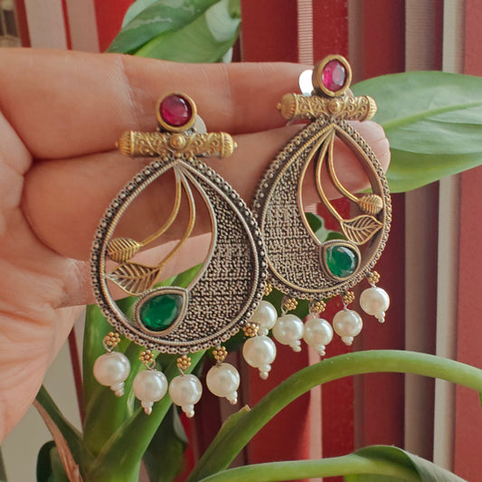 Dual tone earrings with coloured stone with petals in centre