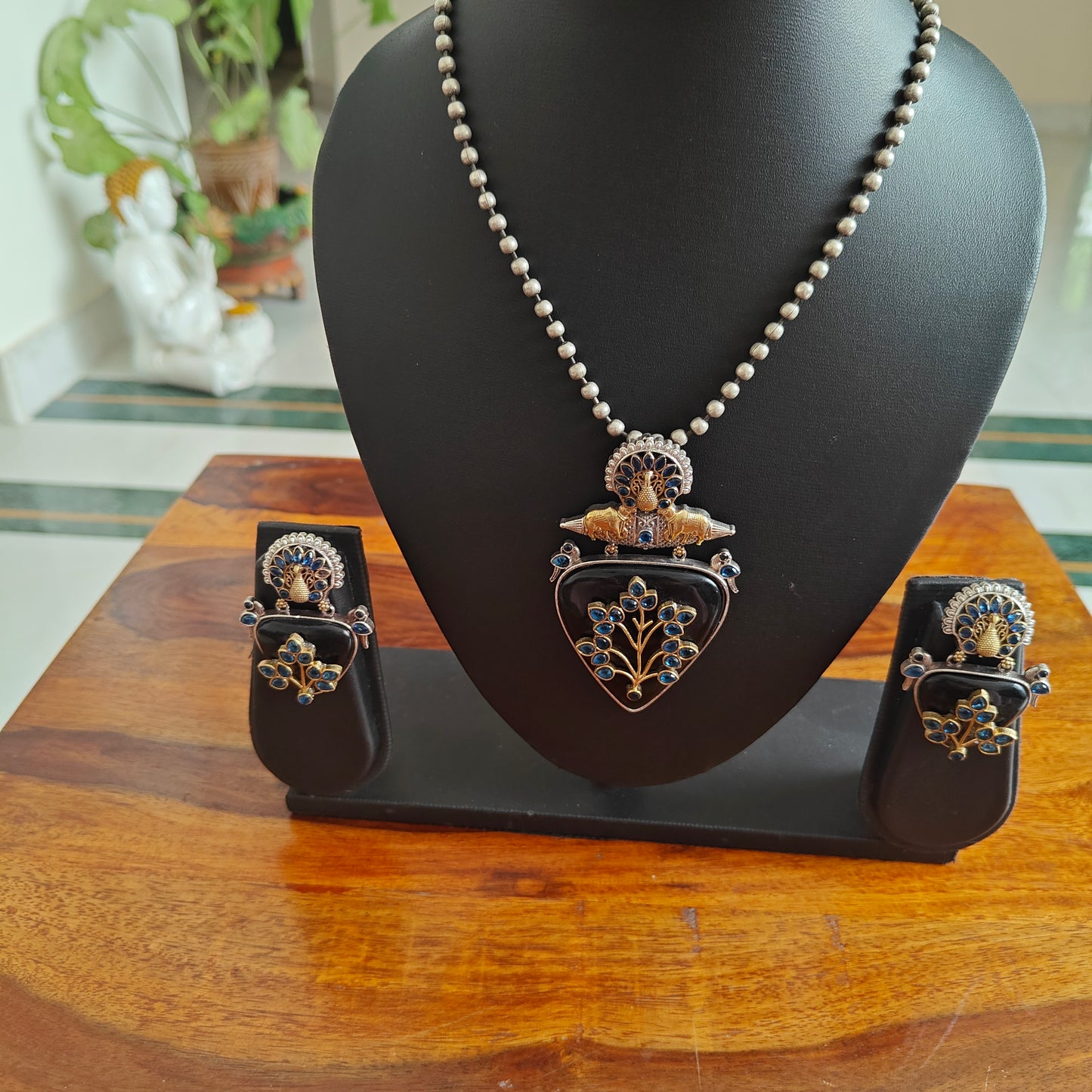 Dual tone set with triangular stone with work and stones highlights on top