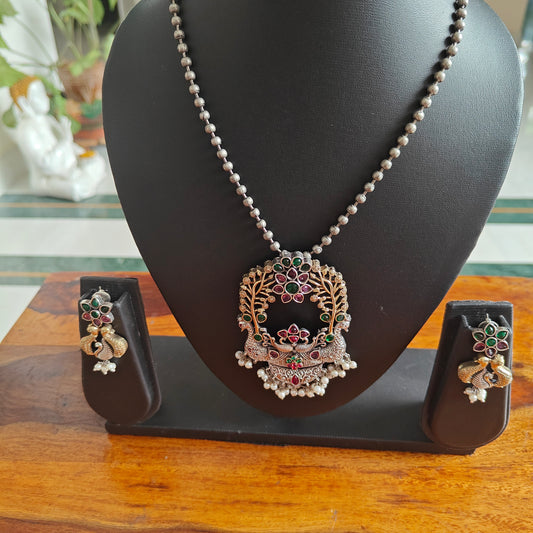 Dual tone two peacock pendant set on bead chain