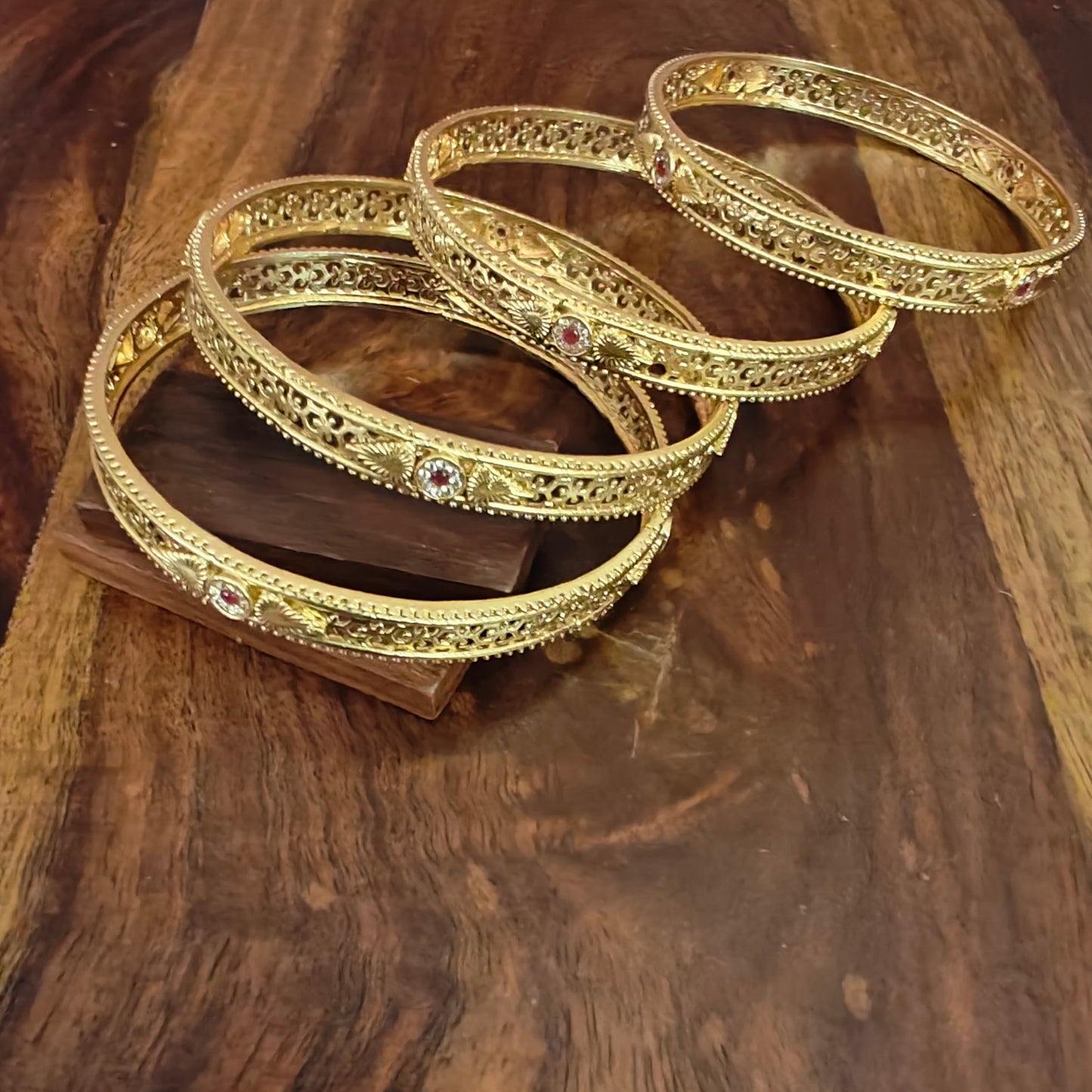 Golden bangles with intricate jali work (4pc)