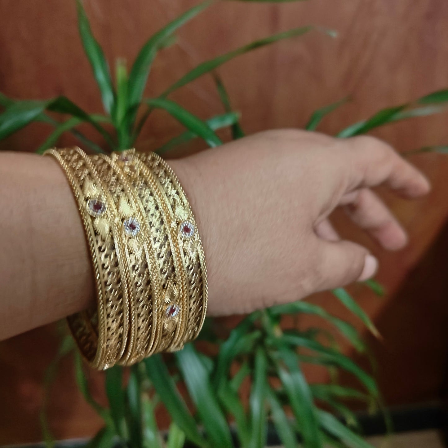 Golden bangles with intricate jali work (4pc)