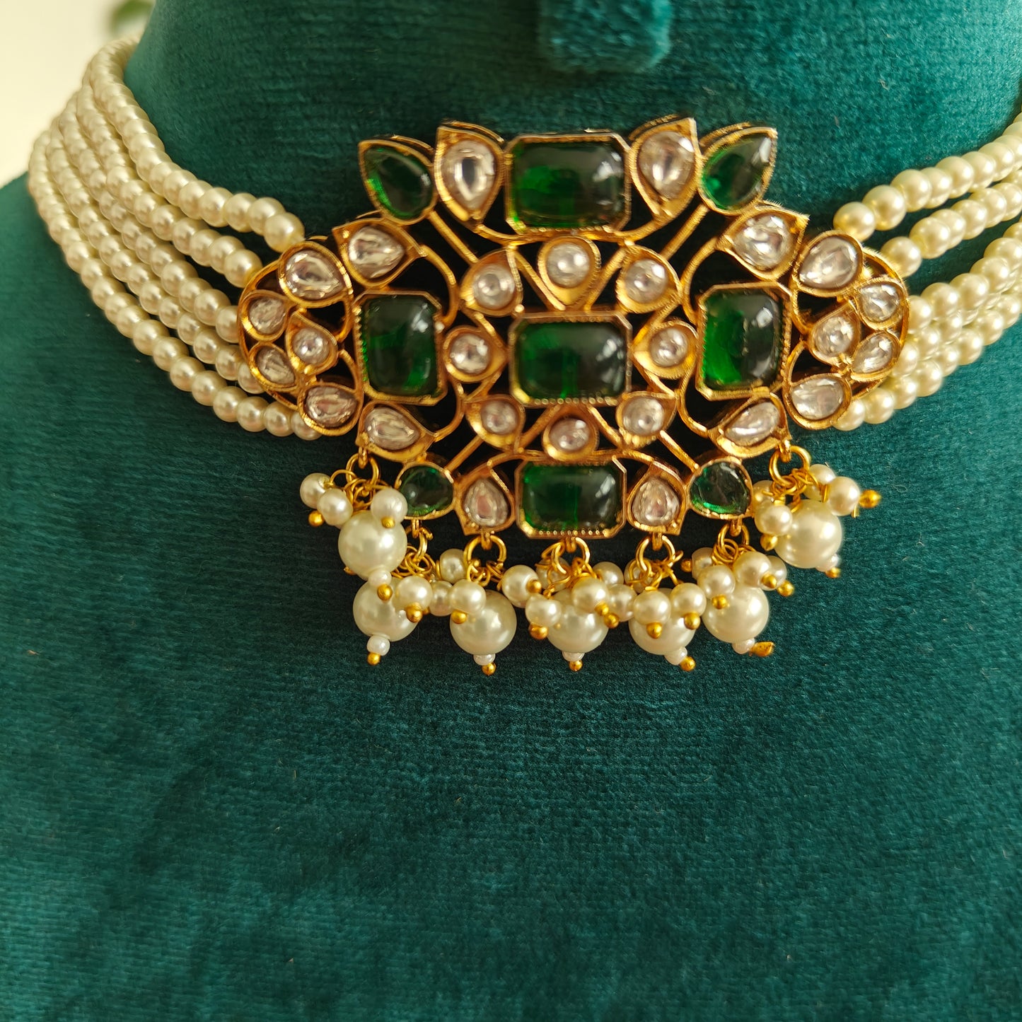 Rupashi choker set with emerald green stones and kundan