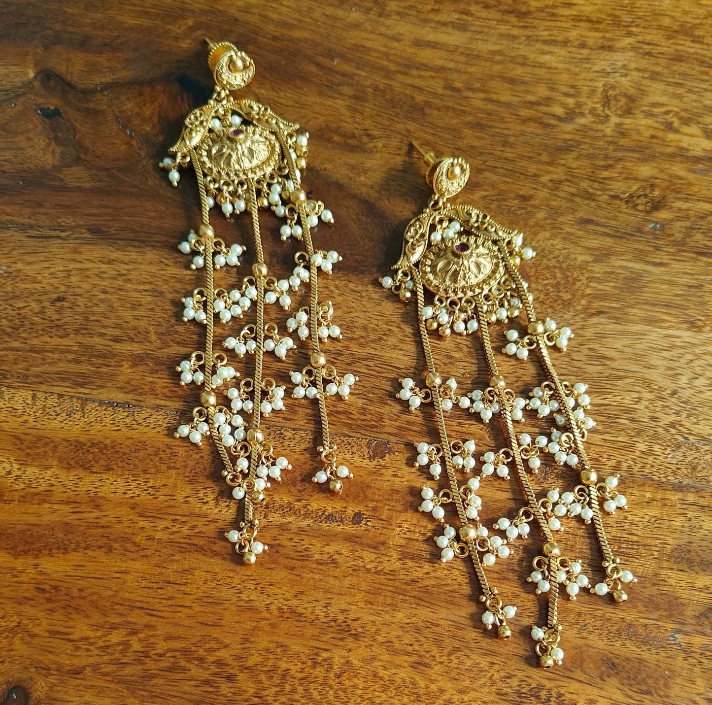Gold earrings with pearls clusters hanging on three chains