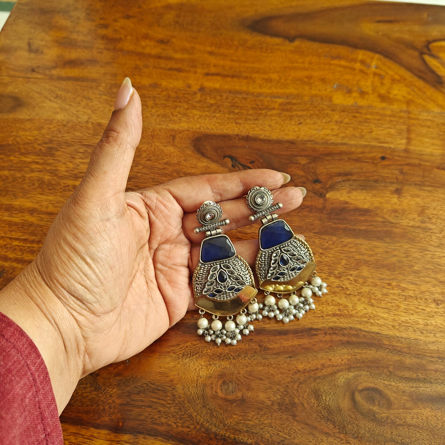 Dual tone earrings with emerald blue stone and pearl hangings