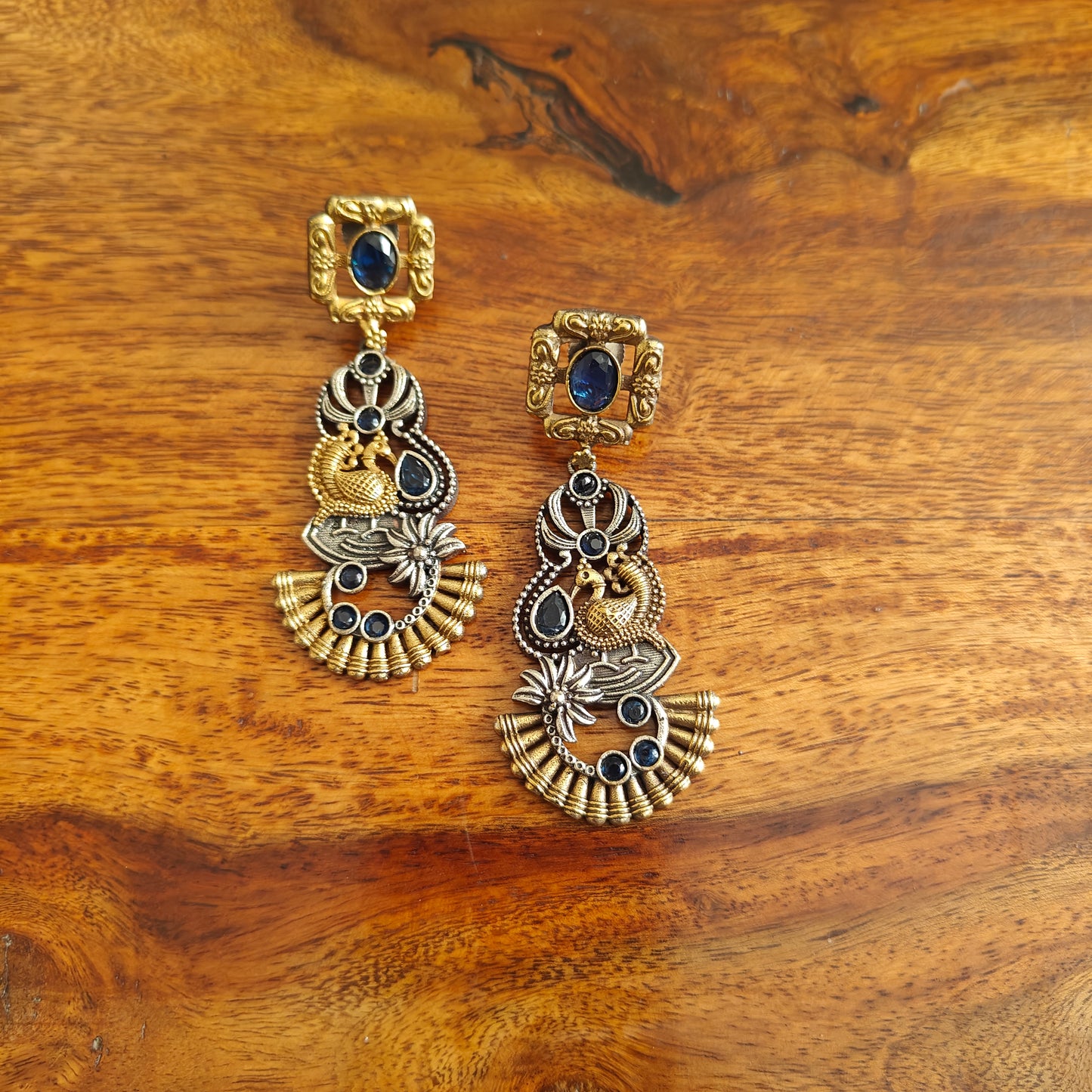 Dual tone earrings with emerald green/sapphire blue stone inlay