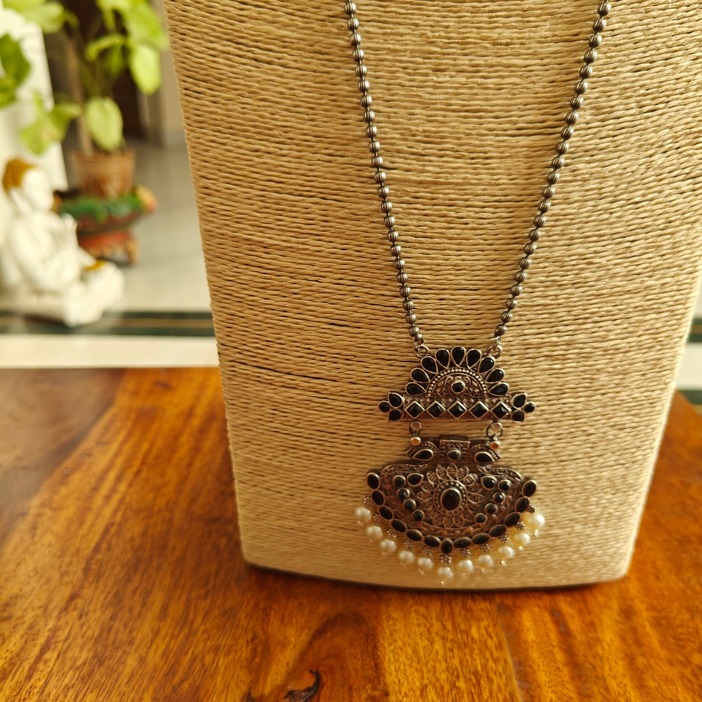 Set on bead chain with pendant with stones