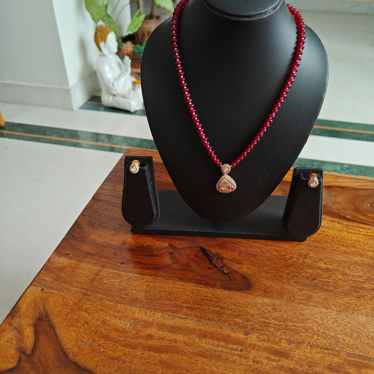 Radhana set with stone string and moissanite on shell.