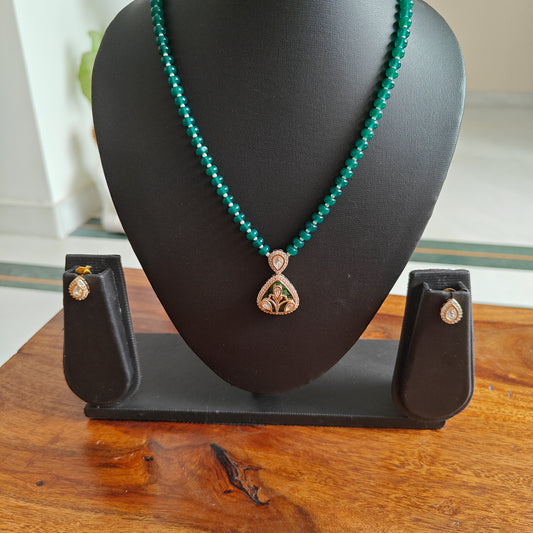 Radhana set with stone string and moissanite on shell.