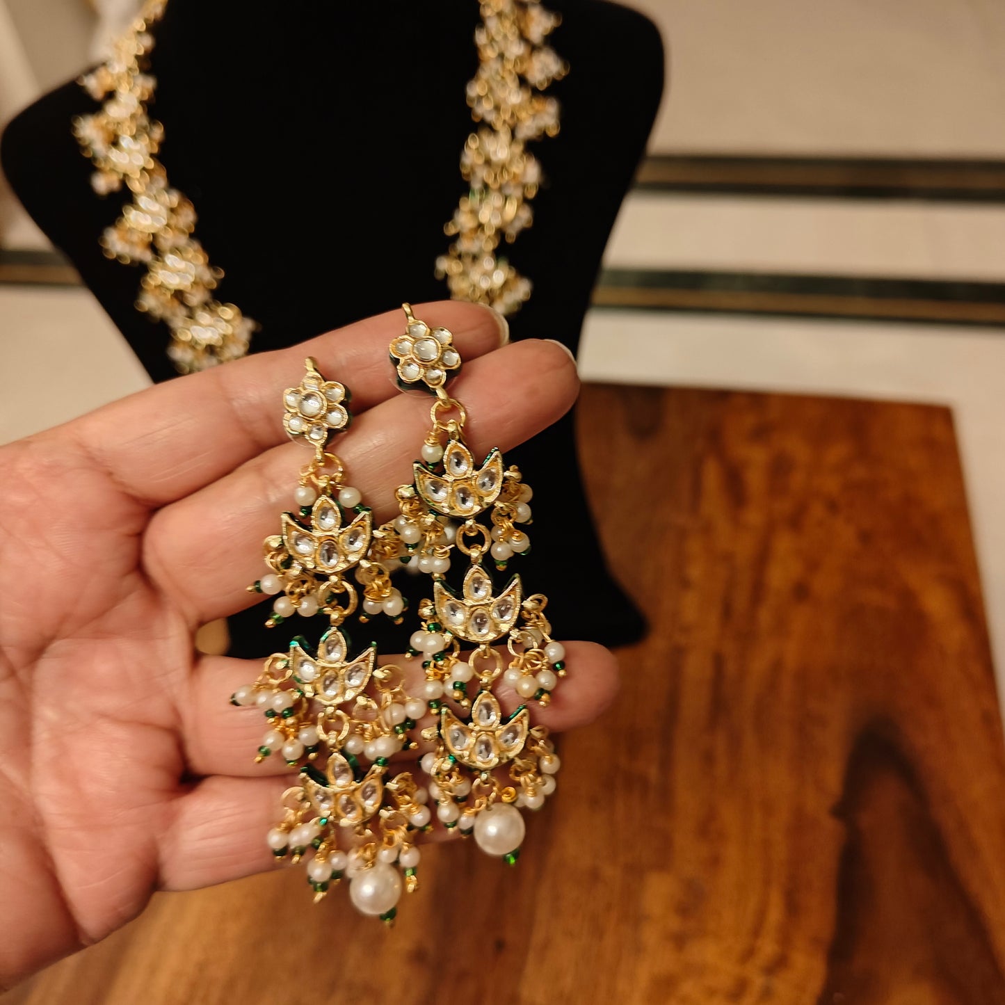 Rajshri set with kundan pieces and pearls hangings
