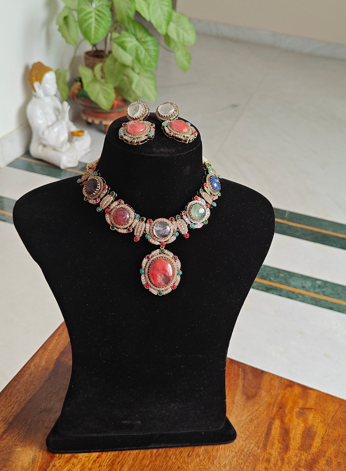 Swaha set with multicolour stones, pendant below with navratan highlights.