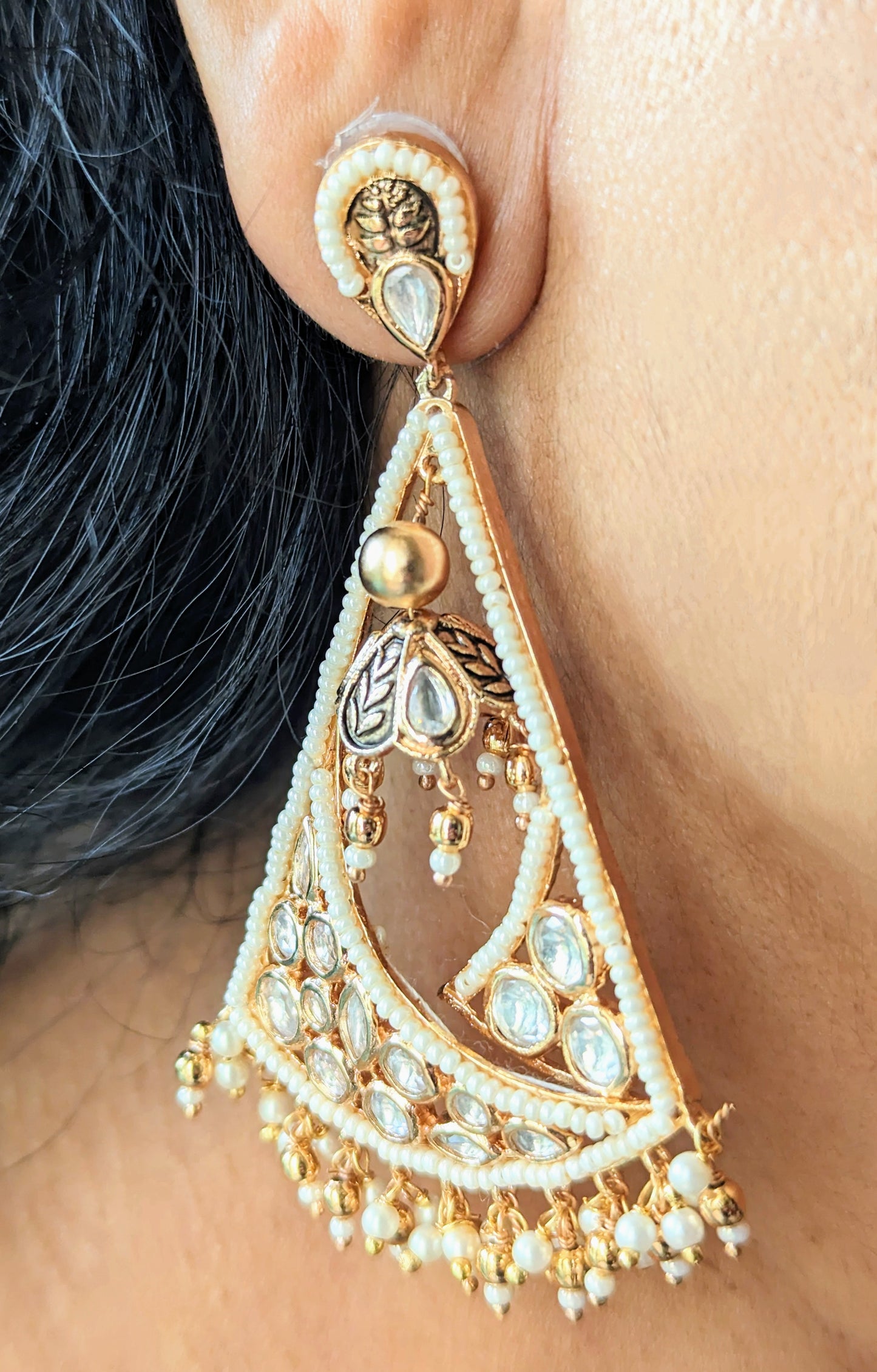 Poth pearl and Kundan triangular hanging earrings.