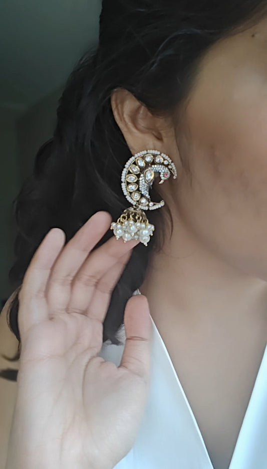 'Chaand-mor' jhumki earrings featuring a peacock nestled in a cresent