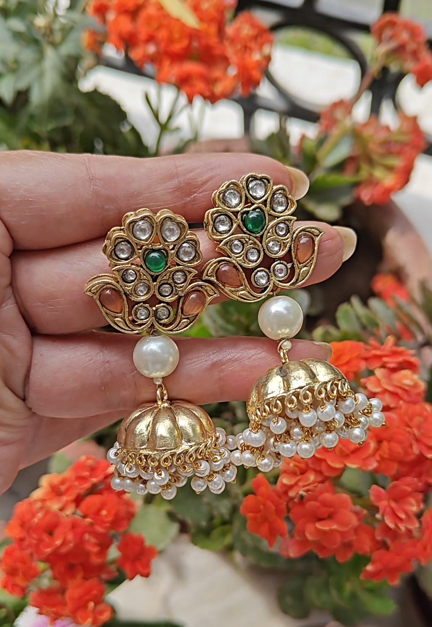 Golden jhumkas on kundan work flower stud