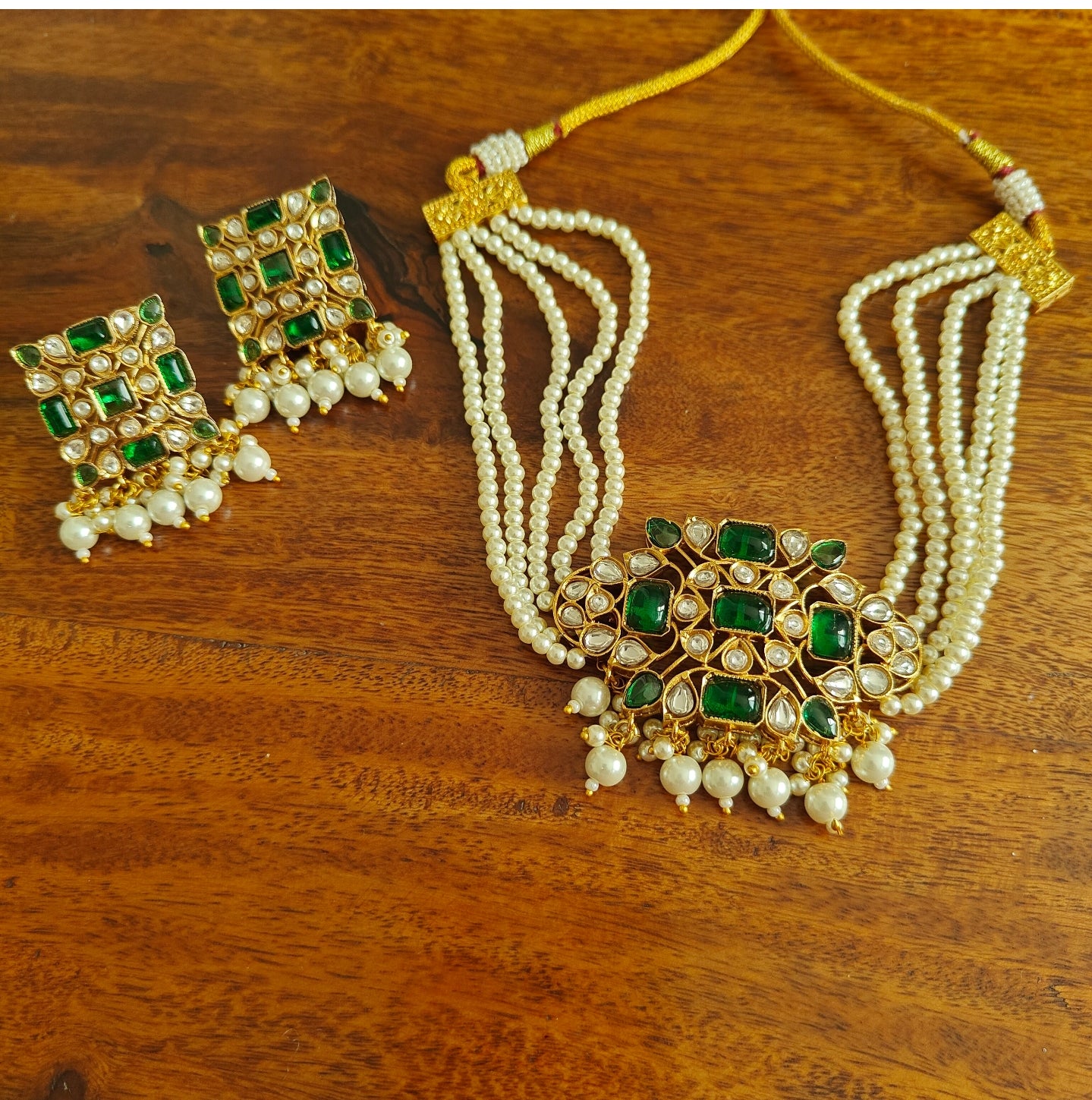 Rupashi choker set with emerald green stones and kundan