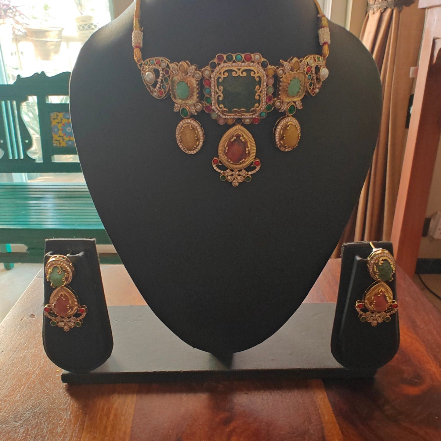 Urvi choker set with emerald green stone and Navratan stones