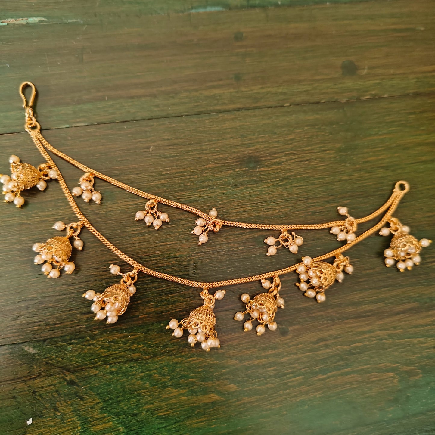 Earchains with golden jhumkis with pearls