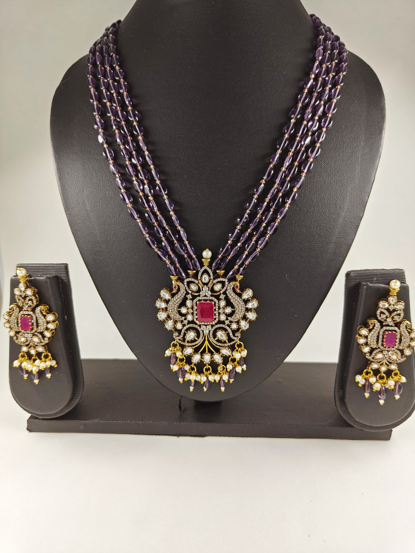 Antique finish set in kundan, CZ and amethyst stone colour