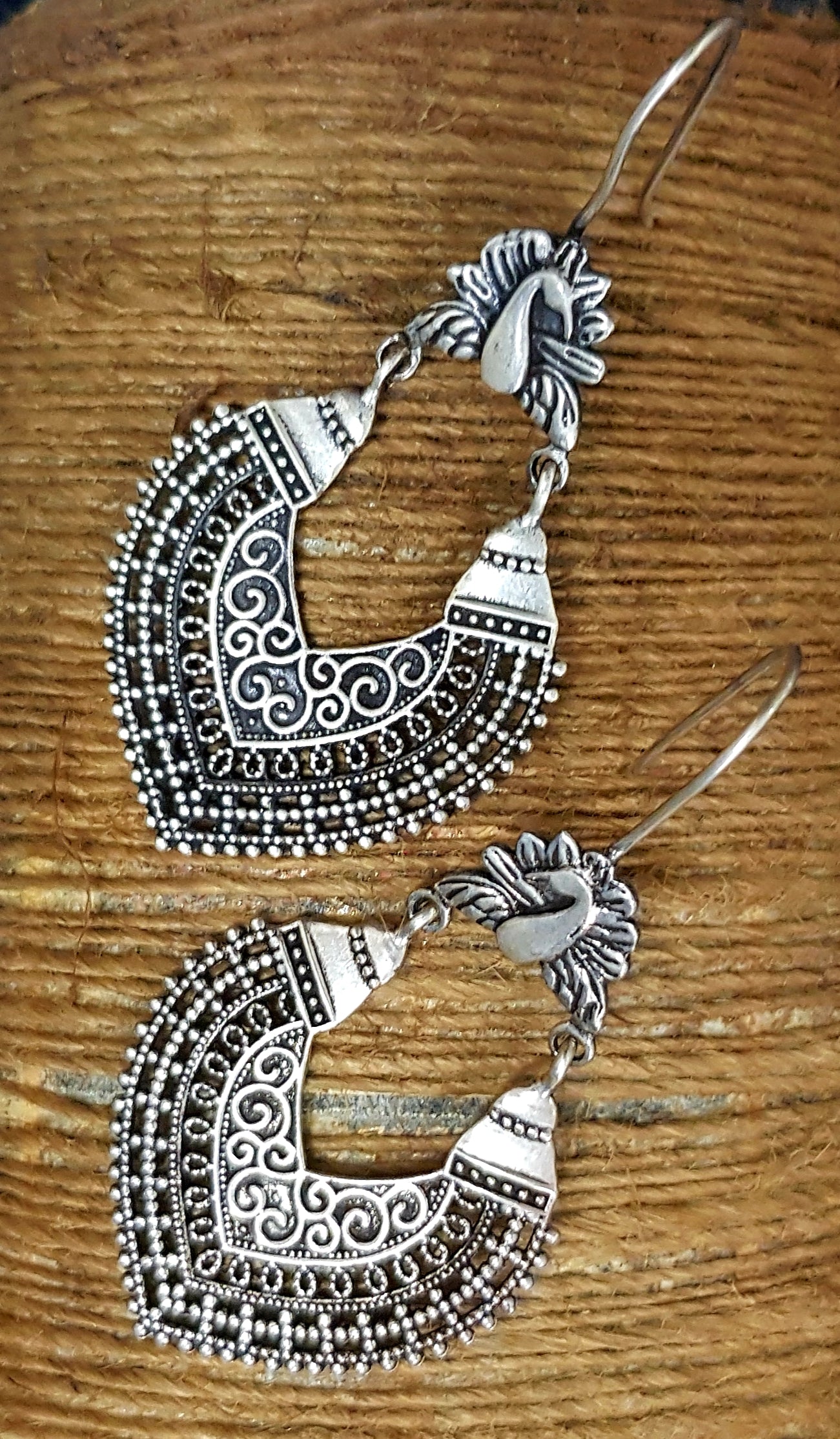 Silver dangler earrings with peacock and jaali design