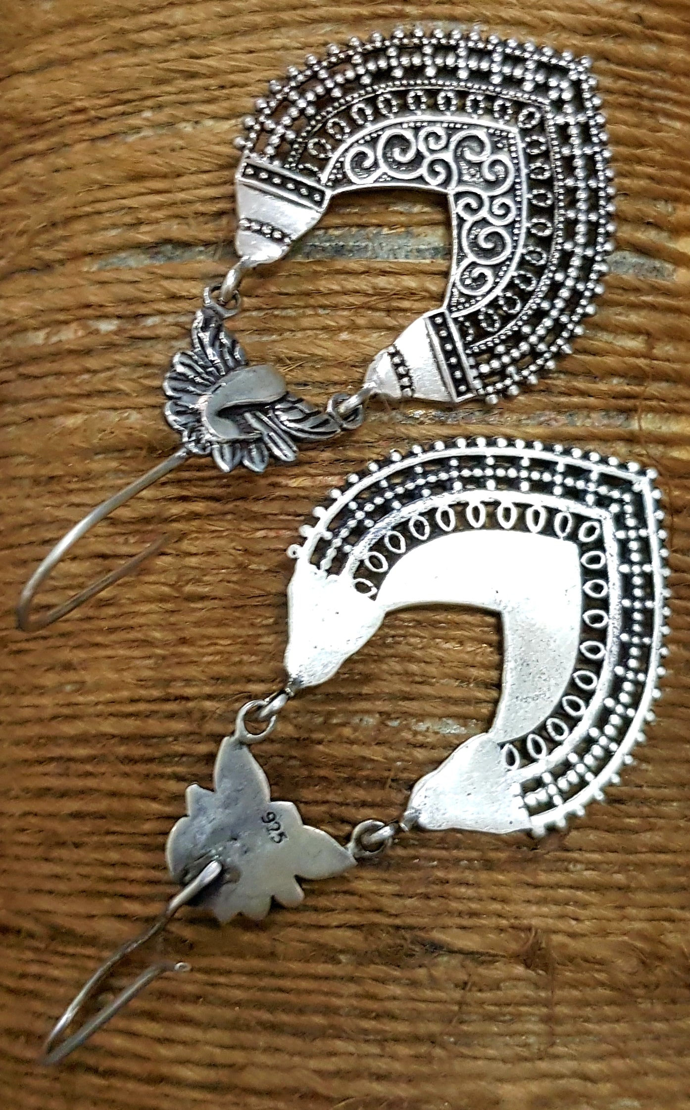 Silver dangler earrings with peacock and jaali design