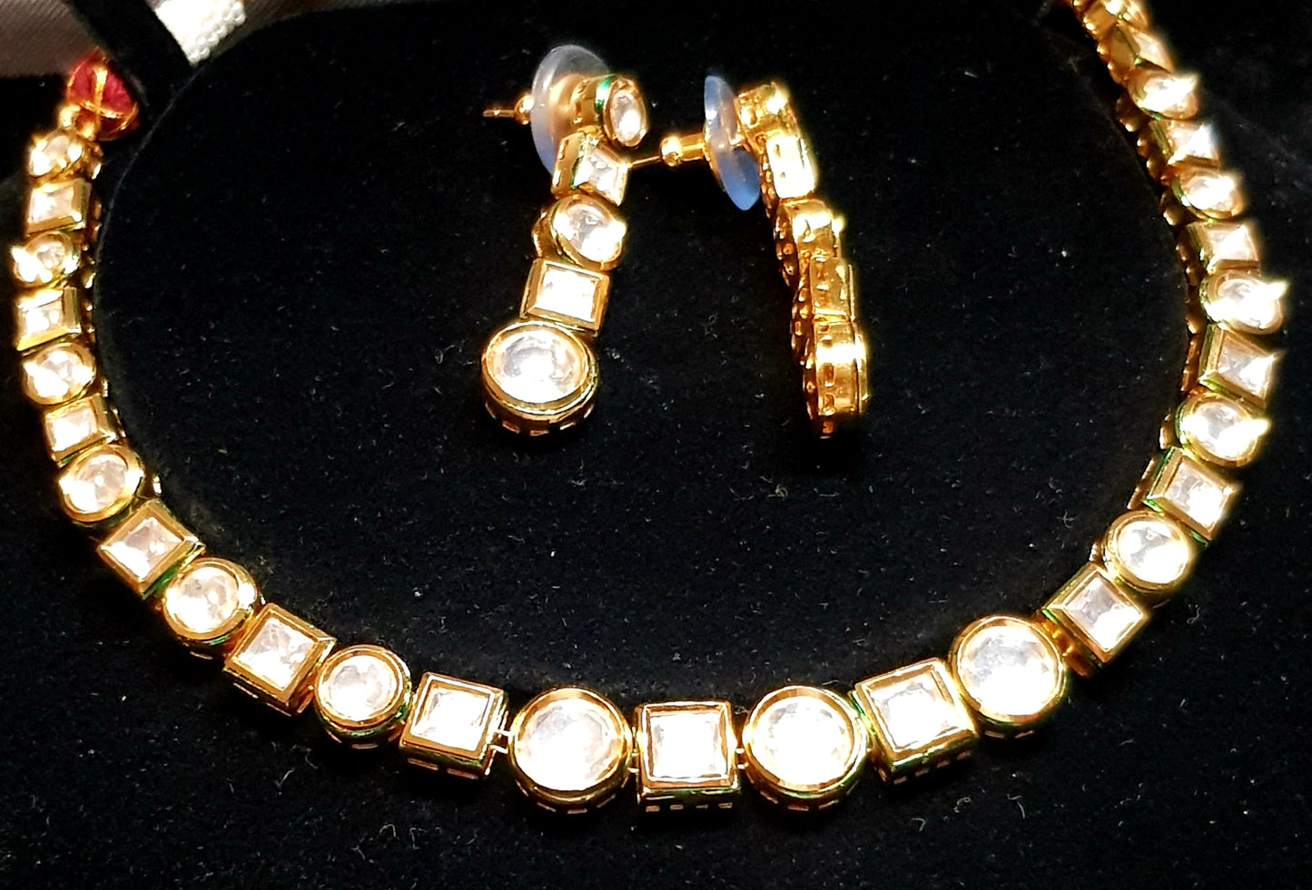 A classy Kundan single strand set with square and round pieces in gold finish