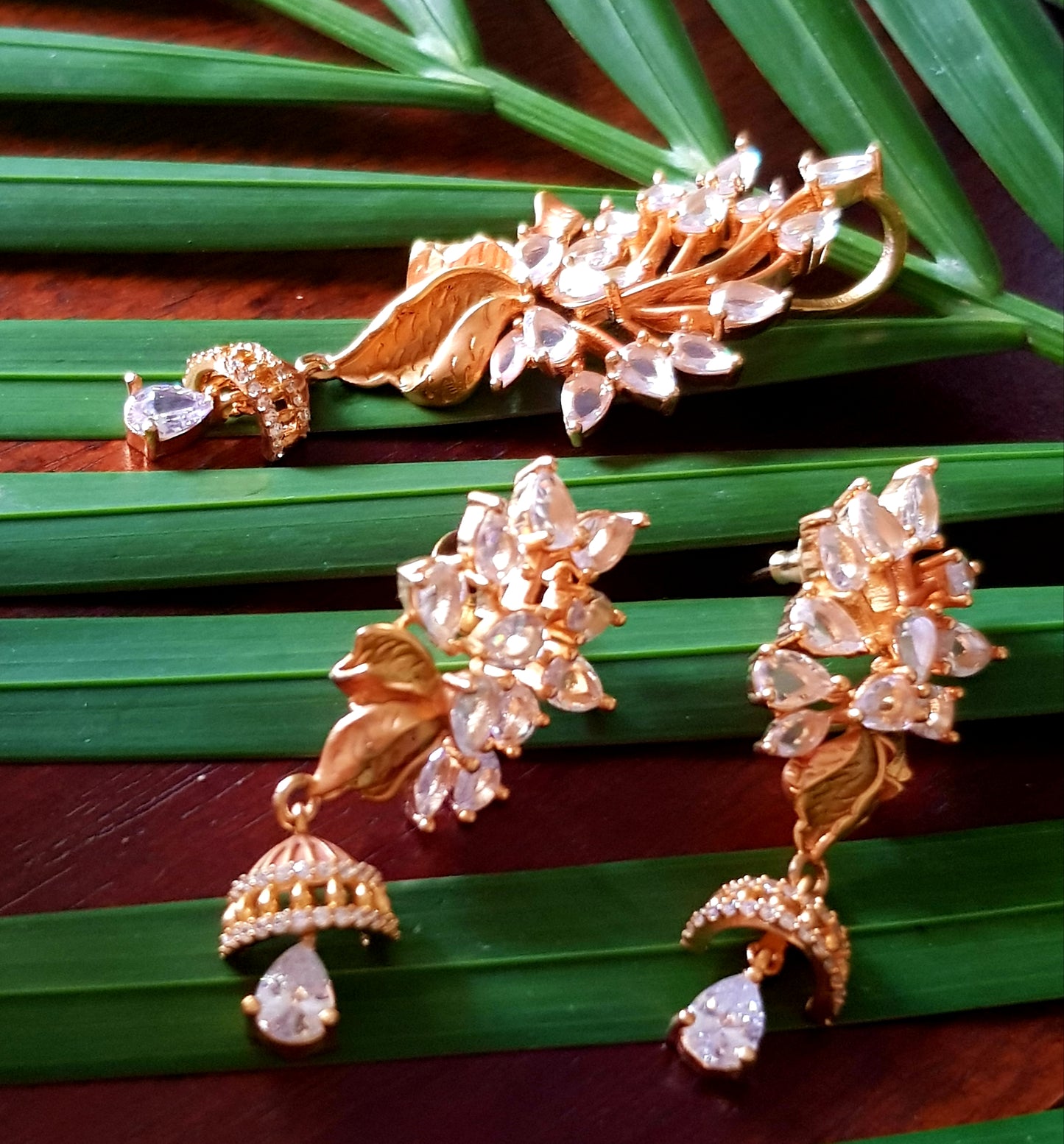 Gold finish flower design pendant set with clear stone and crystal hangings, matching earrings