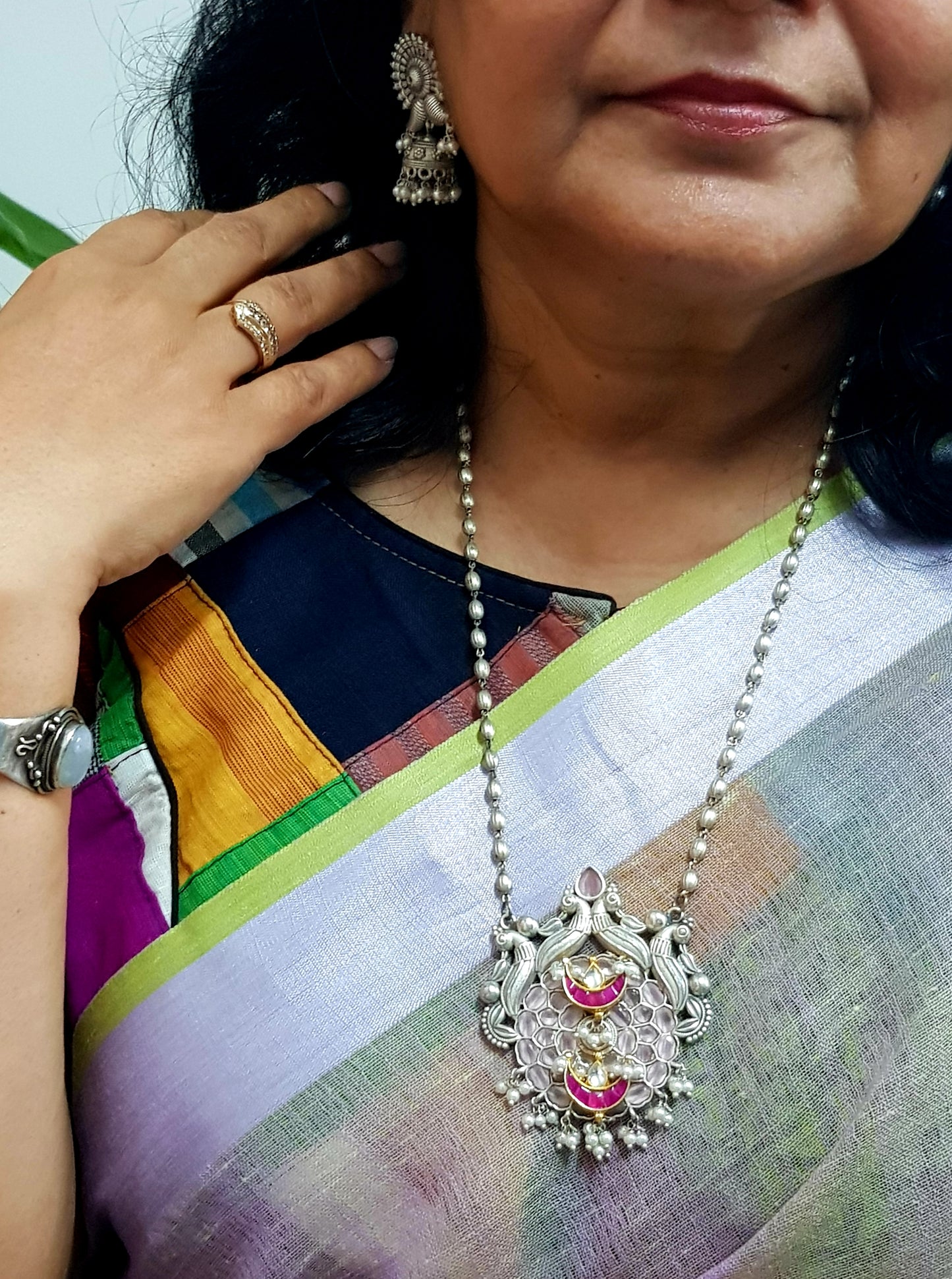 Artistic silver finish set with pendant in light pink and red stones on silver bead string,small jhumkis on studs(earrings)