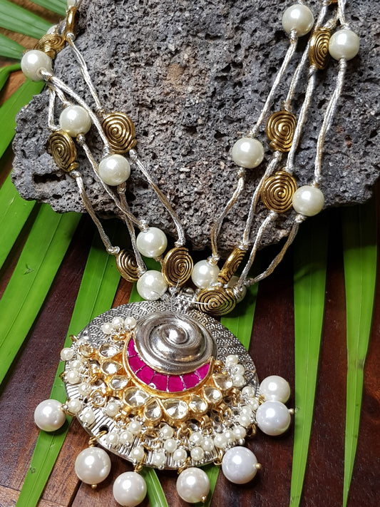 A funky set in silver finish with pearls and golden coils on multiple strings ,a pendant with red/green  stone,kundan and pearls,Big earring/jhumkis