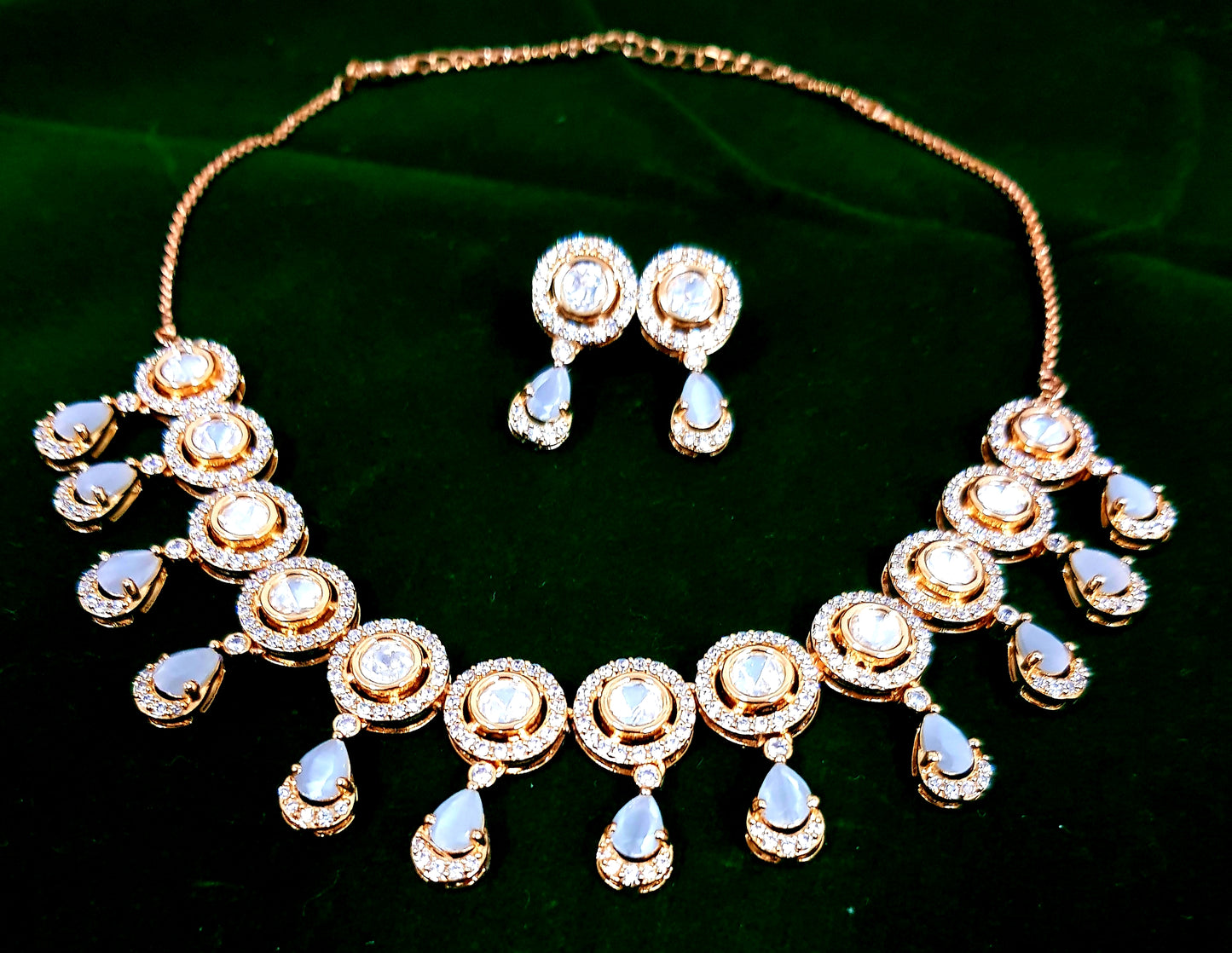 A beautiful kundan single strand set in gold finish and CZ detailing, stone hangings and matching earrings