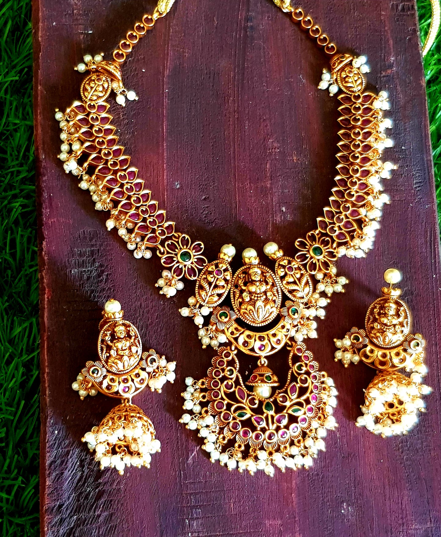 Temple jewelry set, necklace with Goddess Lakshmi motif and red stones detailing, matching jhumkas (earrings)