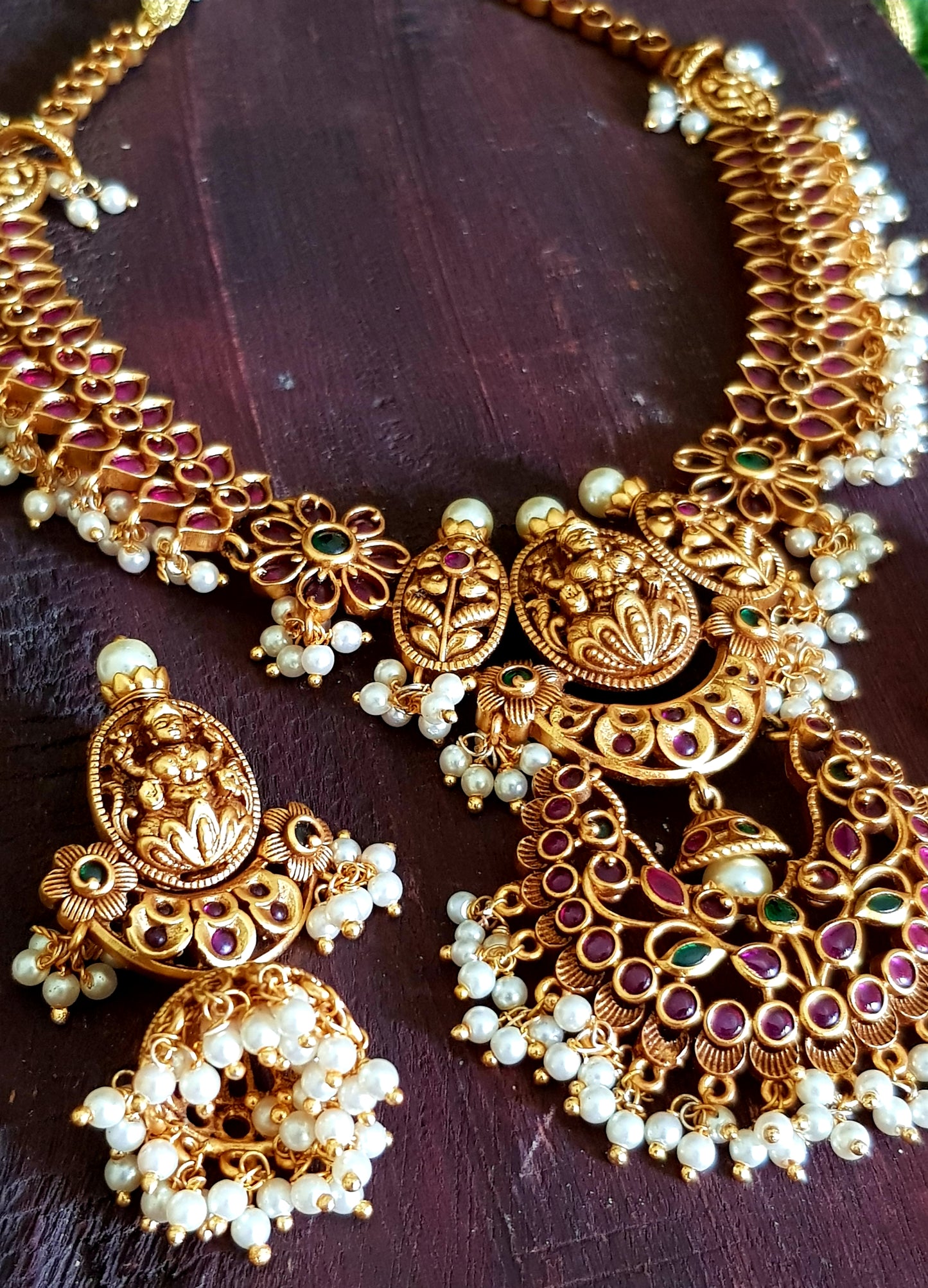 Temple jewelry set, necklace with Goddess Lakshmi motif and red stones detailing, matching jhumkas (earrings)