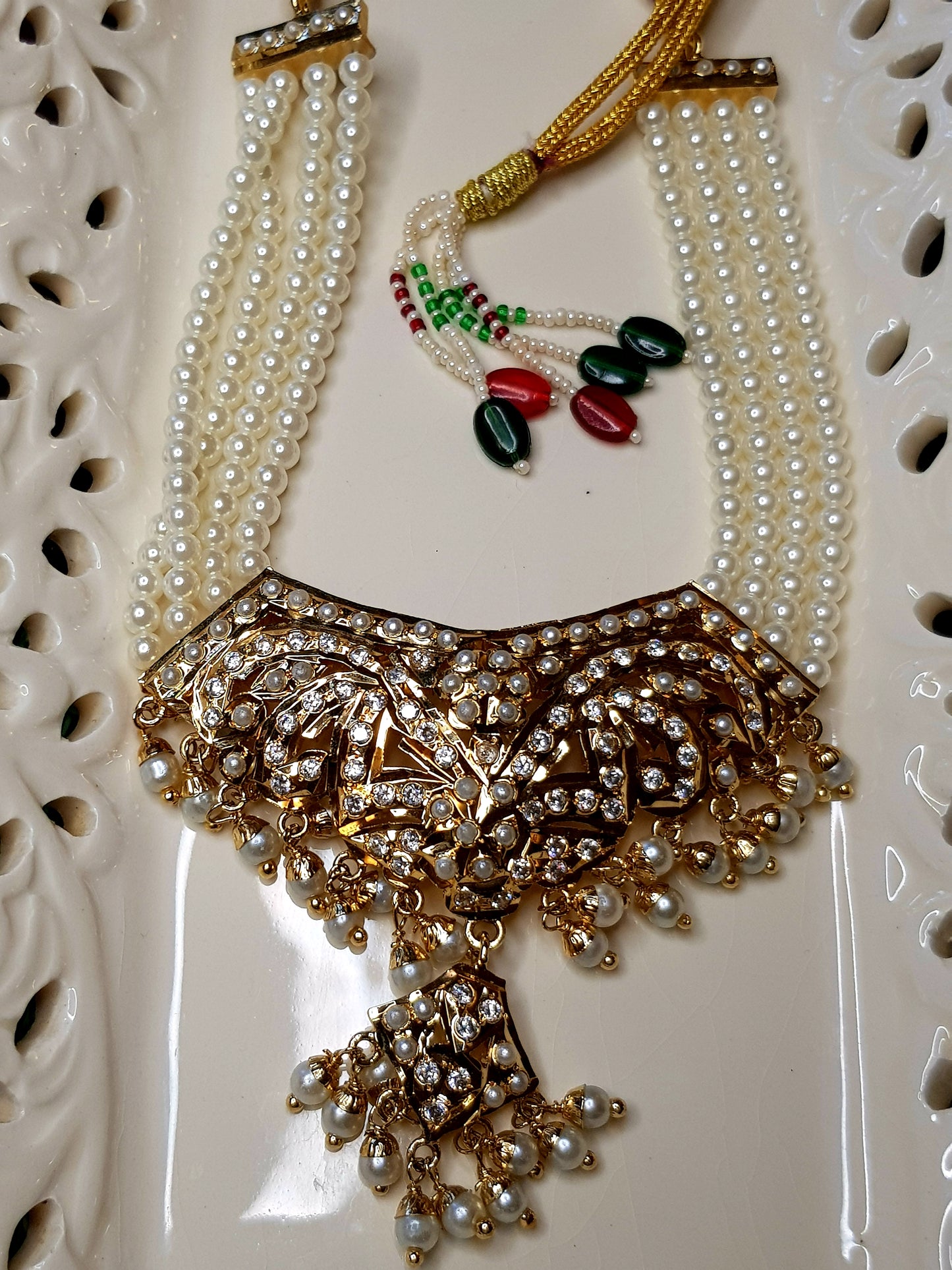 Jadau set in pearls with a hanging pendant, triple pearl strands, in choker style and matching  earrings