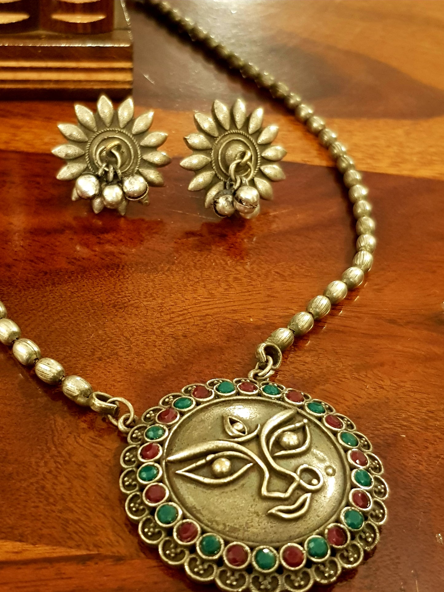 Durga motif necklace and earrings silver finish set with neutral/green and deep pink stone inlay