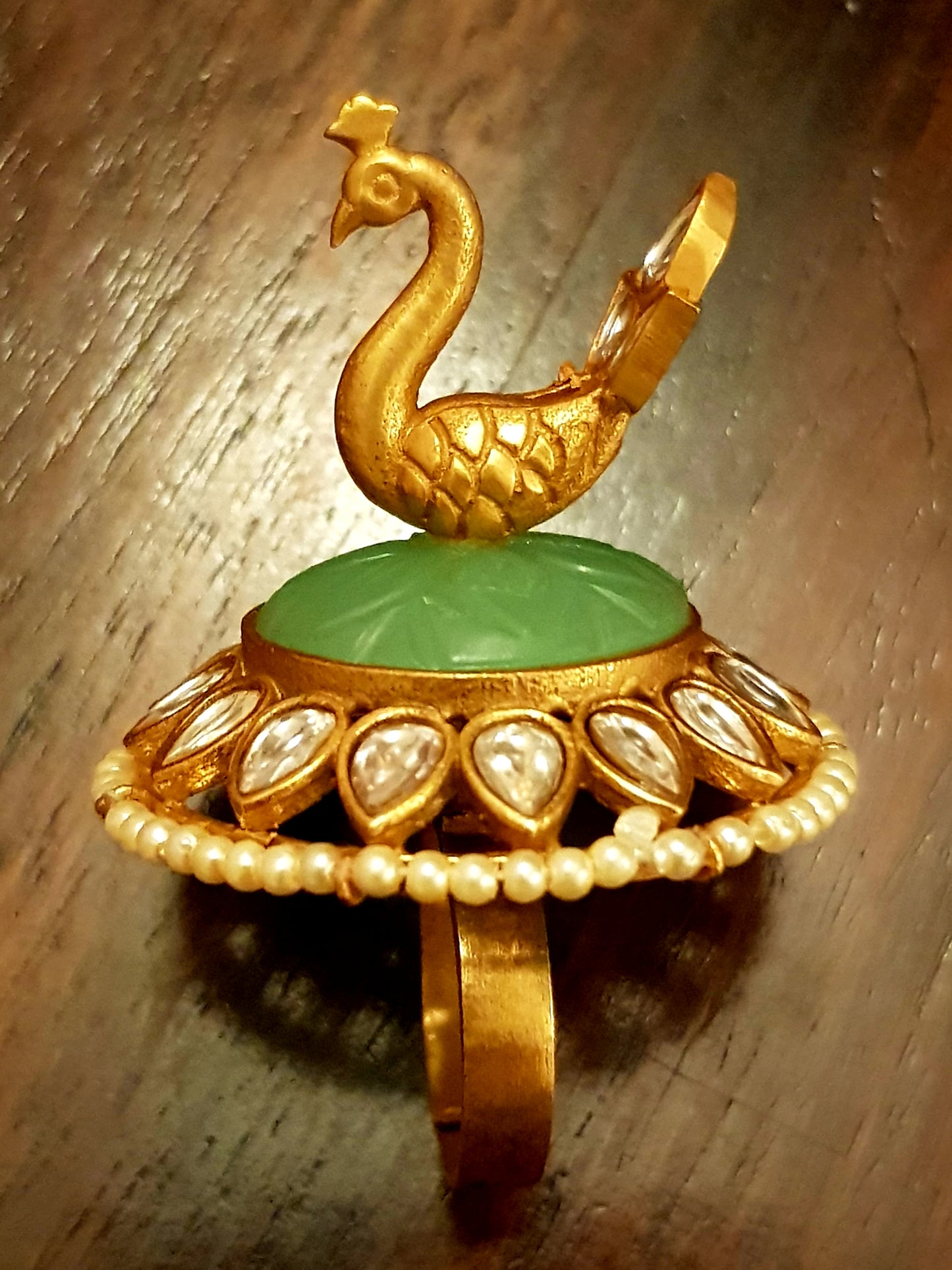 Gold finish, perched peacock on light green stone ring