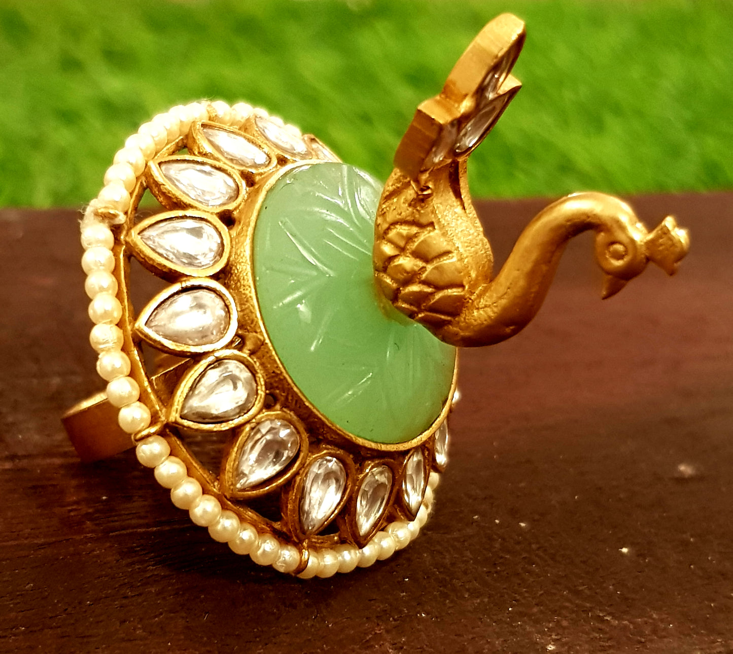 Gold finish, perched peacock on light green stone ring