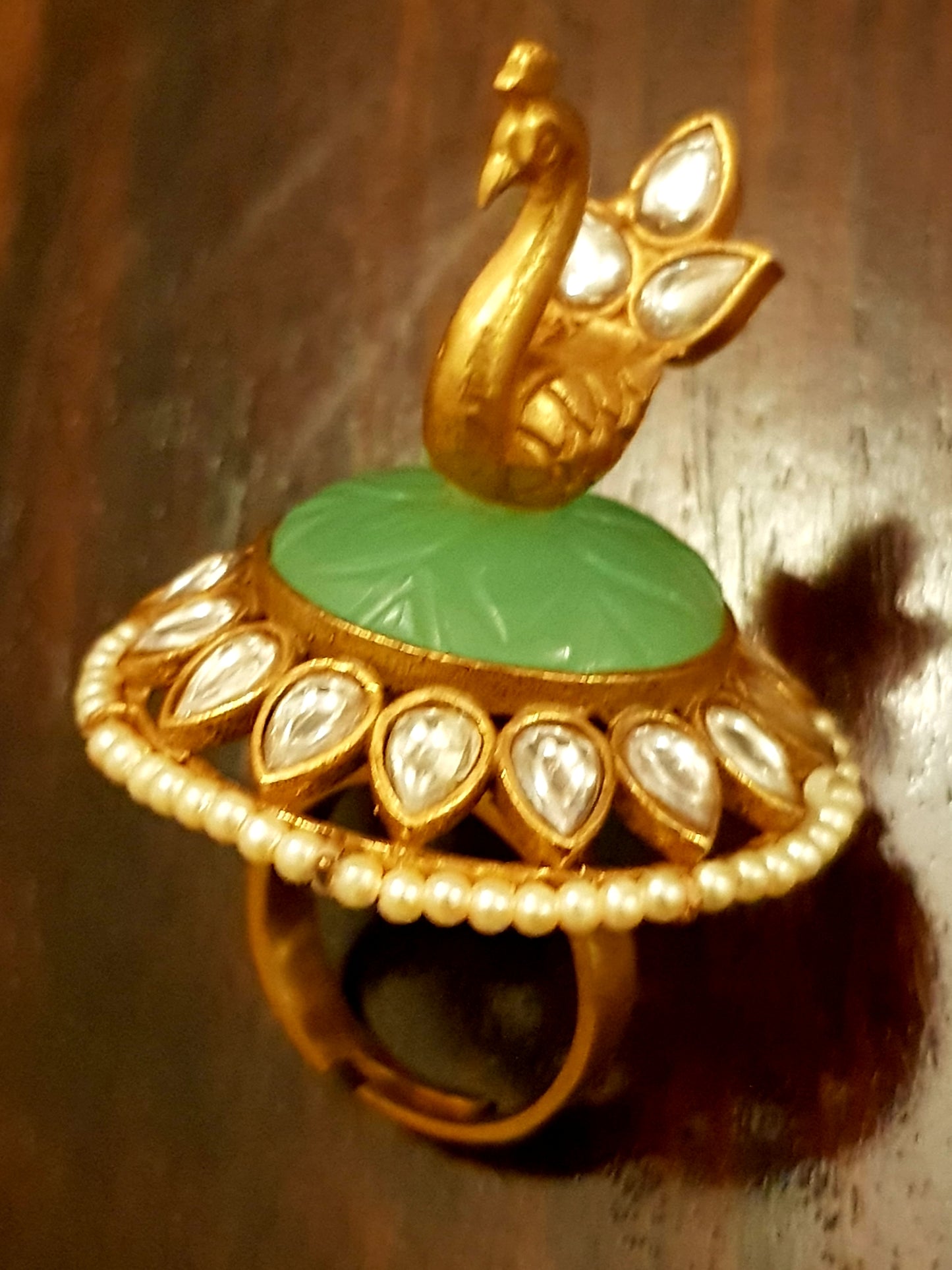 Gold finish, perched peacock on light green stone ring