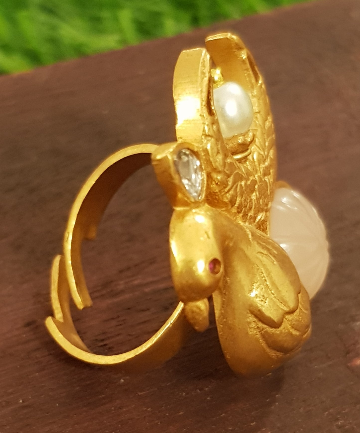 Gold finish bird motif ring with pale pink stone, kundan and pearl